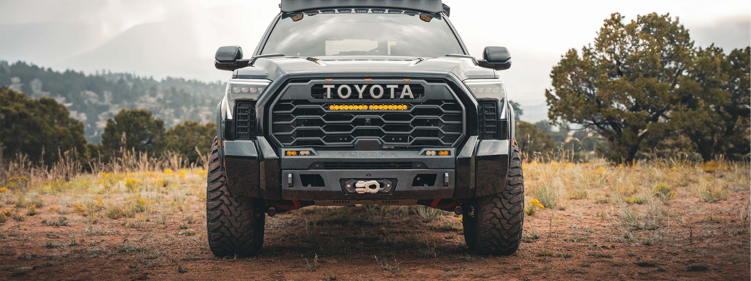 Toyota Tundra with a Backwoods Adventure Mods Front Bumper installed and mountains in the background