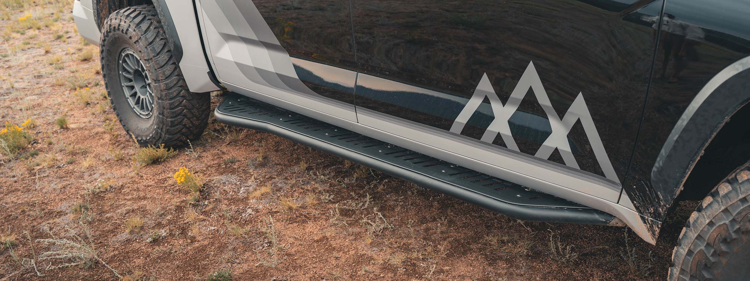 Toyota Tundra with rock slider installed serving as a side step and running board will adding protection off road