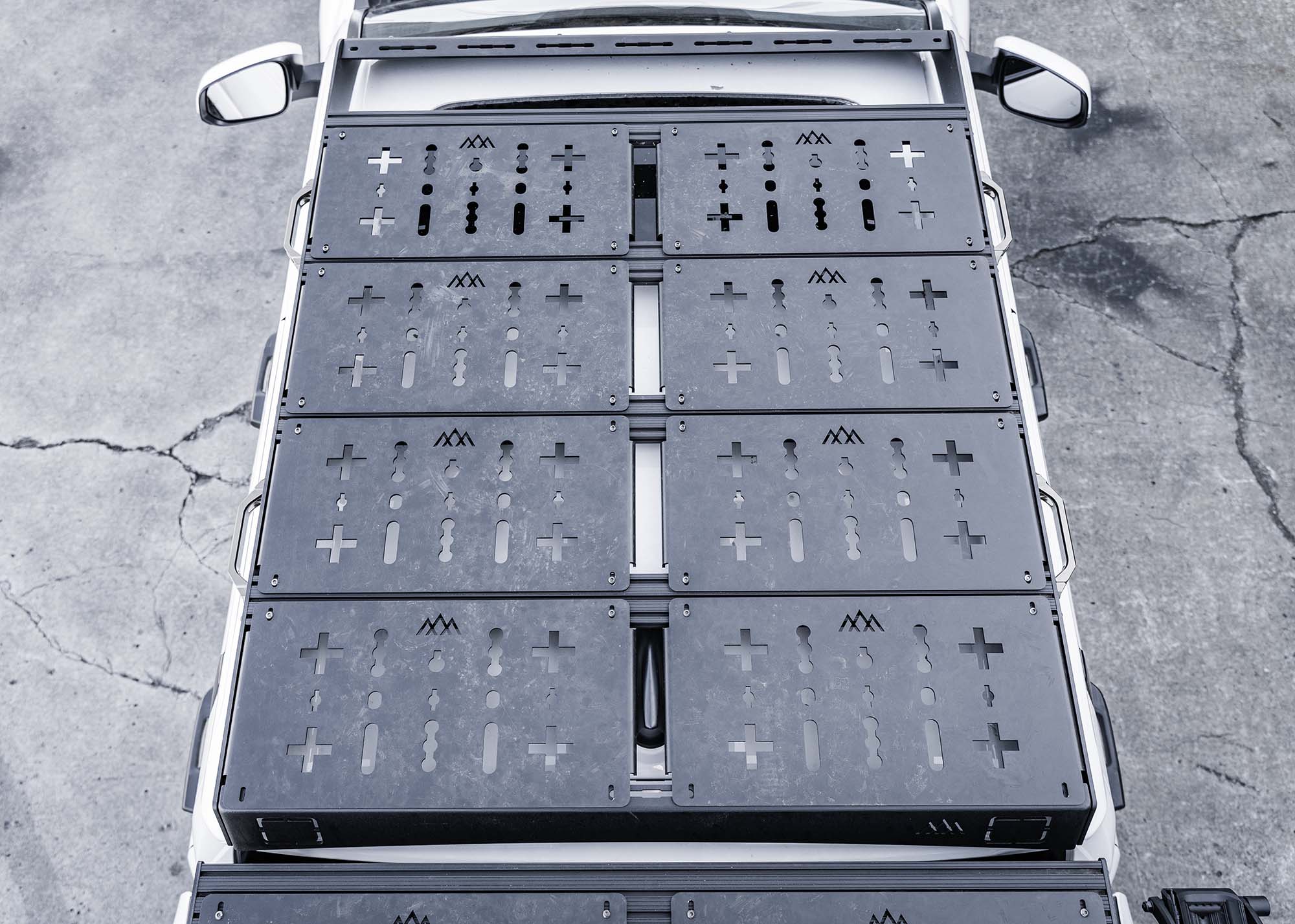 Top view of Backwoods Adventure Mods DRIFTR roof rack on a white 2024 4th gen Toyota Tacoma with modular cargo deck panels installed