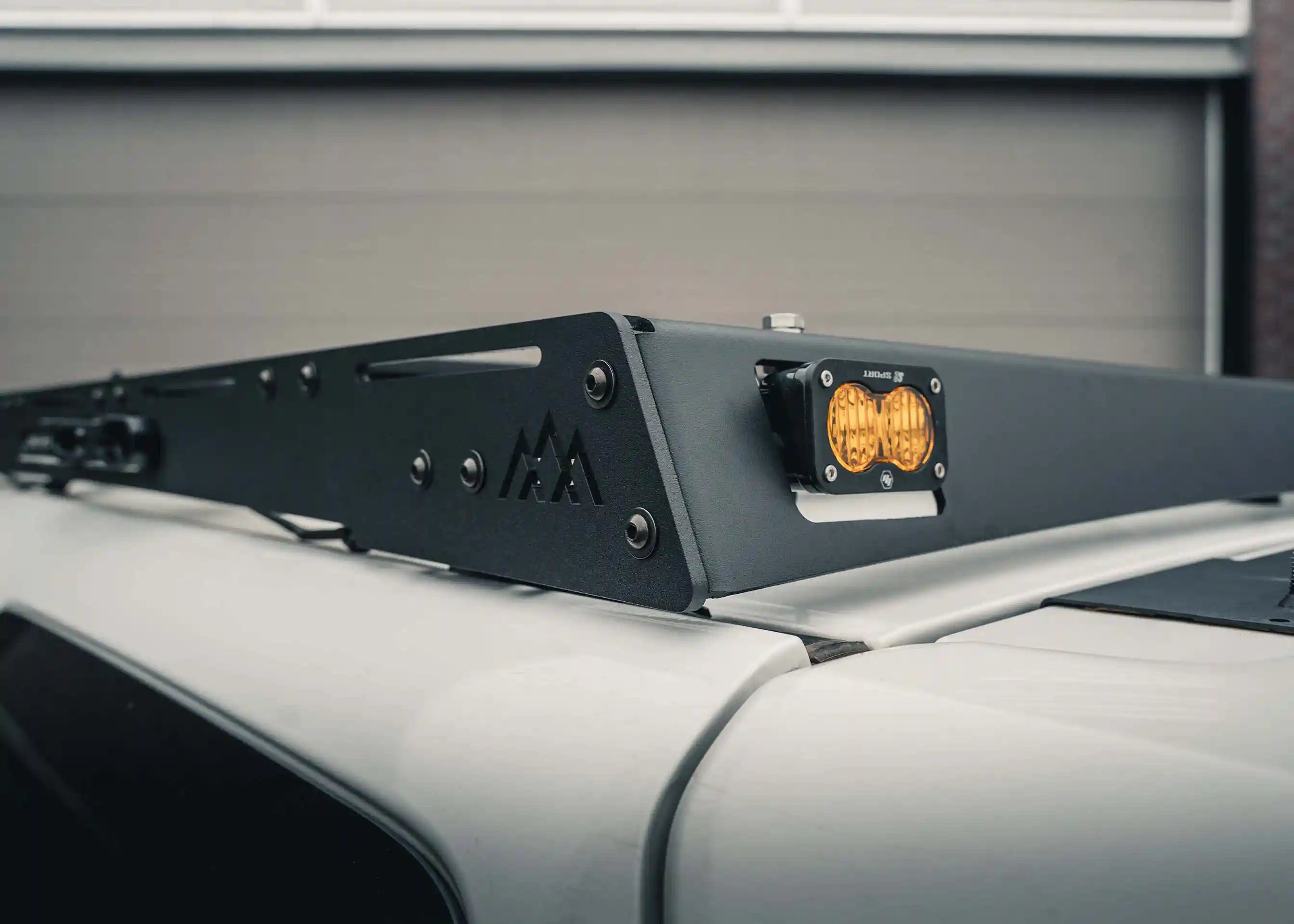 Off road chase light mount in the rear fairing of the Backwoods Adventure Mods 2005-2023 2nd and 3rd Gen Toyota Tacoma DRIFTR Roof Rack