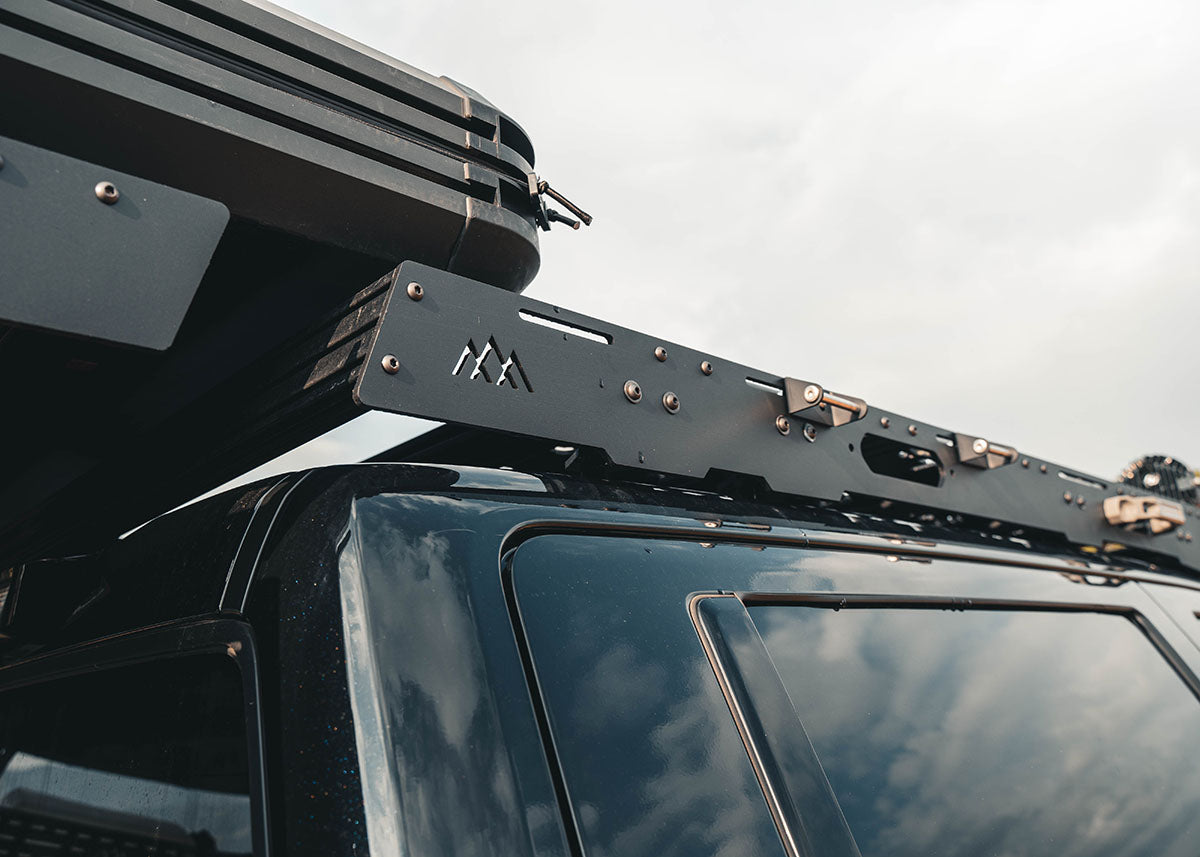 Rear profile image of the Backwoods Adventure Mods DRIFTR 3rd Gen Toyota Tundra roof rack with modular t-track accessory load bars