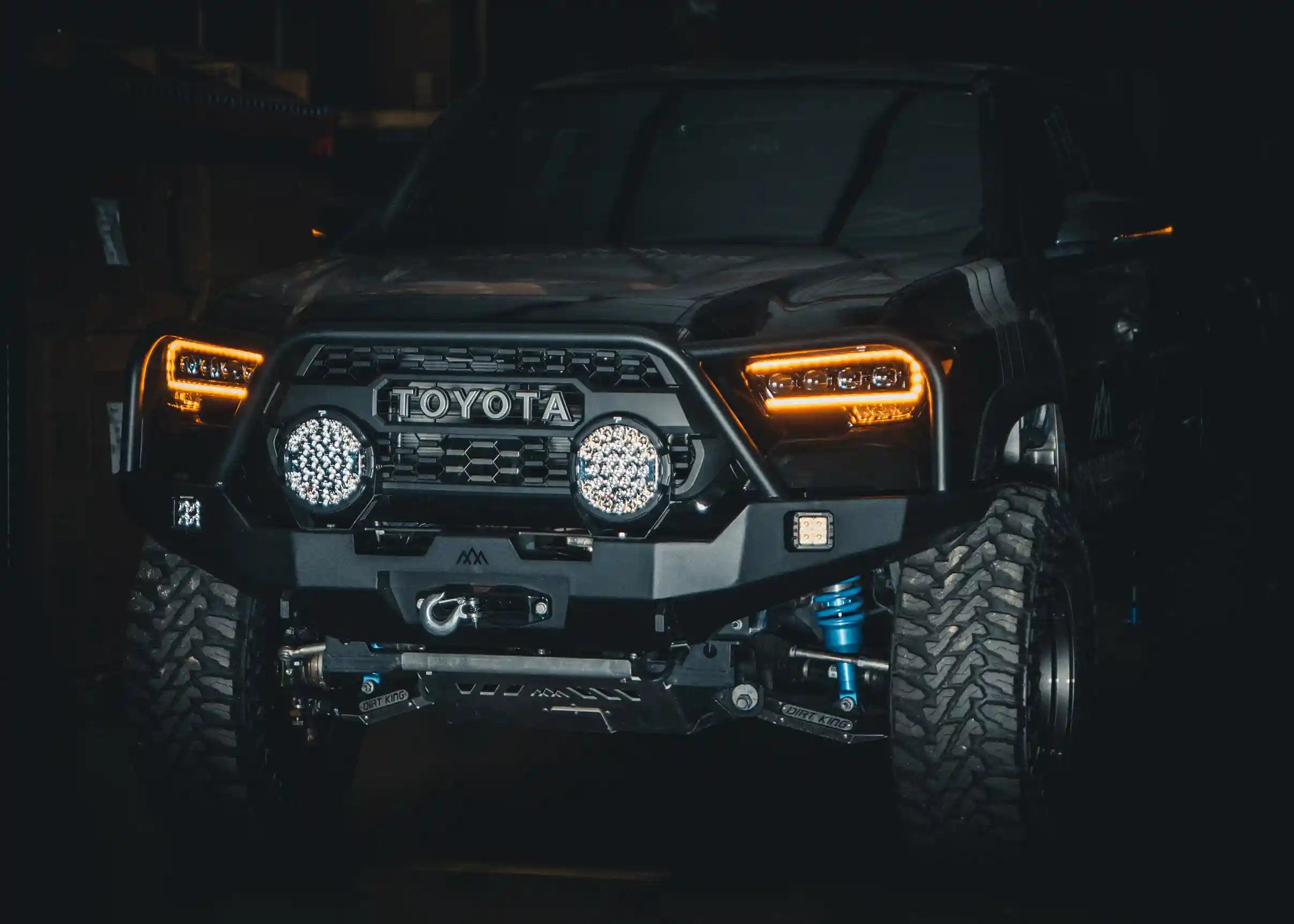 Black 3rd gen Toyota Tacoma with Backwoods Adventure Mods 2016-2023 Tacoma Front Bull Bar Bumper mounted and winch installed for off roading and overlanding