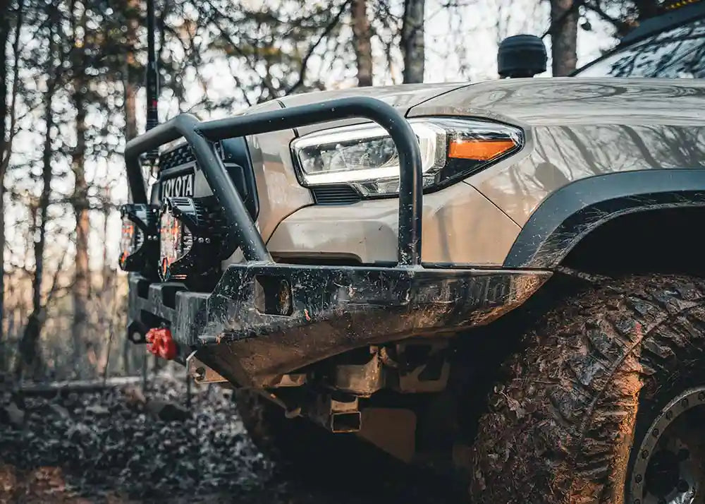 Image showing the high clearance of the Hi-Lite Overland Tacoma Front Bumper with Bull Bar installed on a 3rd Gen Tacoma equipped with a winch and off road lights mounted
