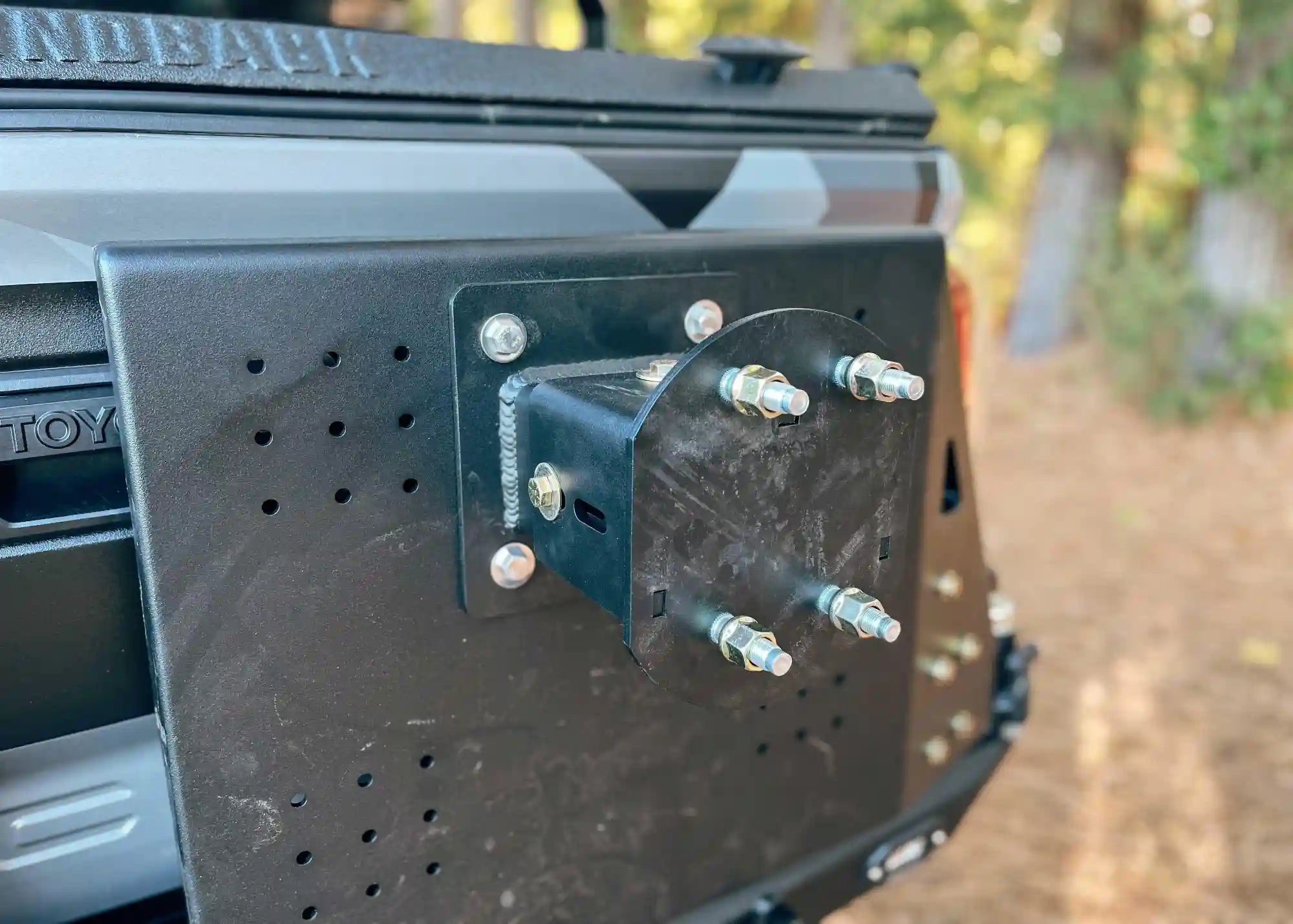 Close up of the spare tire mount on the Backwoods Adventure Mods 2016-2023 3rd Gen Toyota Tacoma Hi-Lite High Clearance Dual Swing Out Rear Bumper