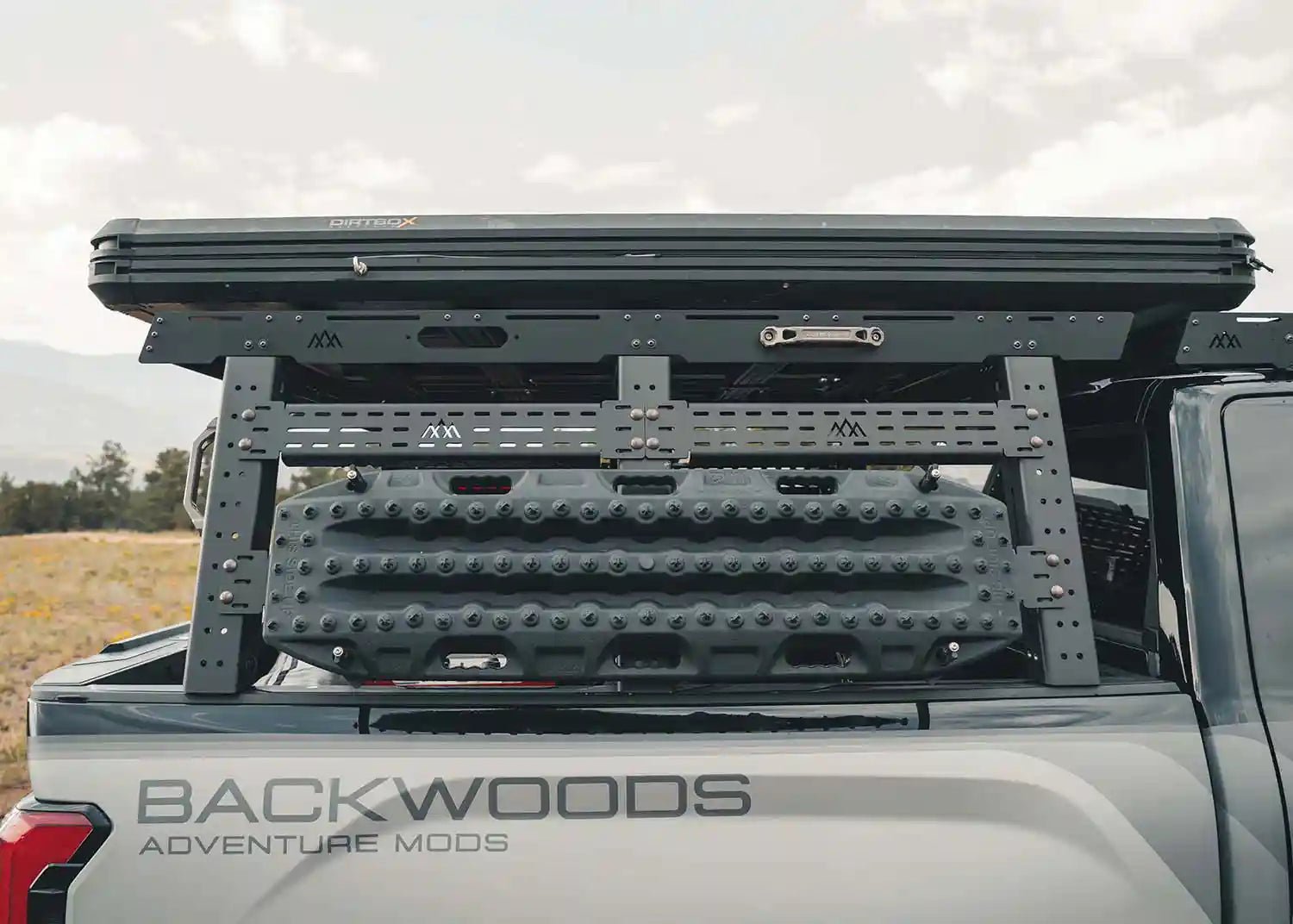 Backwoods Adventure Mods Bed Rack DRIFTR Topper cargo carrier installed on a 2022+ 3rd Gen Toyota Tundra bed rack with a roof top tent mounted on top