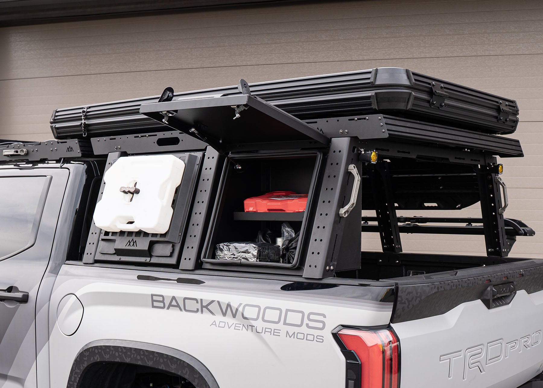 Backwoods Adventure Mods 3rd Gen Toyota Tundra Bed Rack installed with optional bed rack cargo storage boxes with locking lids open