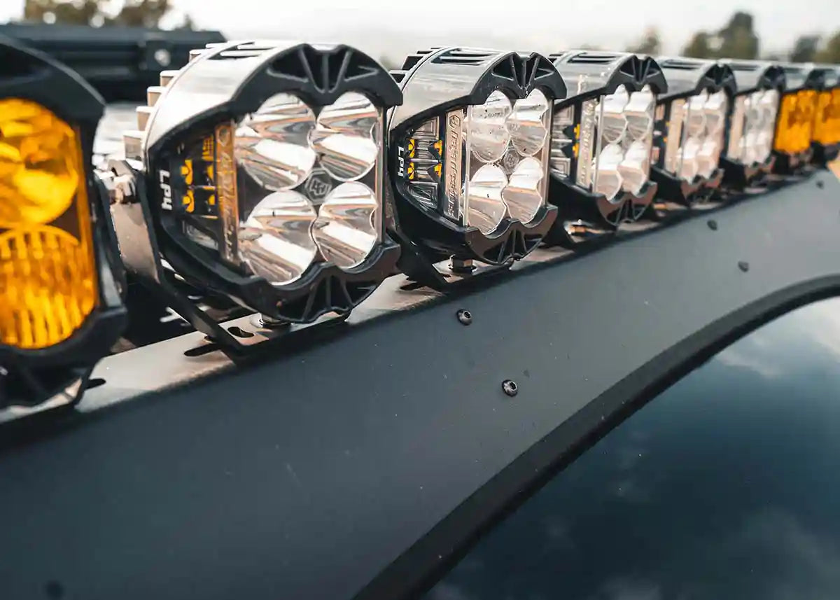 Close up of the Backwoods Adventure Mods DRIFTR roof rack wind fairing installed on a 3rd Gen Toyota Tundra with LED off road lights mounted