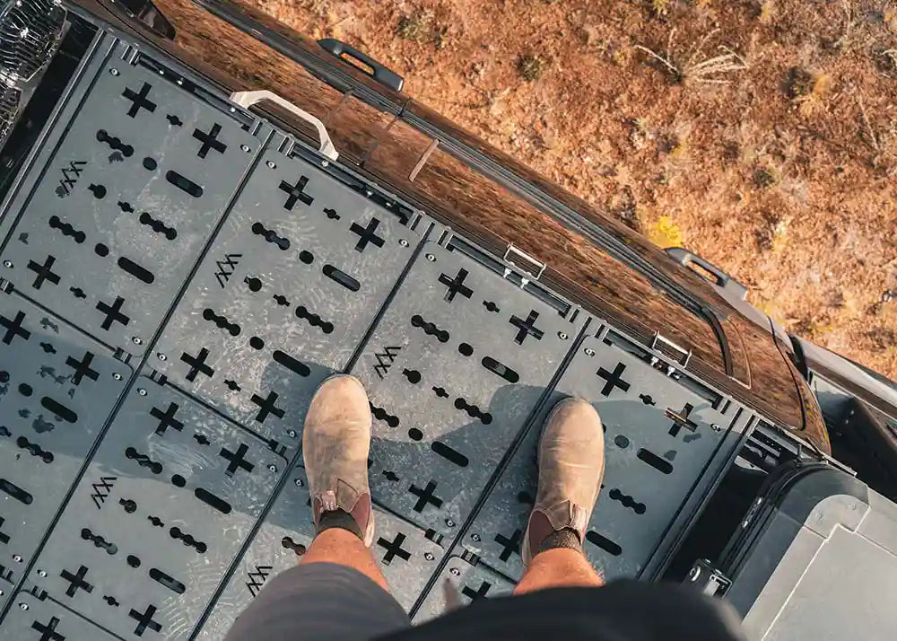 Standing on top of a Backwoods Adventure Mods DRIFTR roof rack installed on a 3rd Gen Toyota Tundra looking down