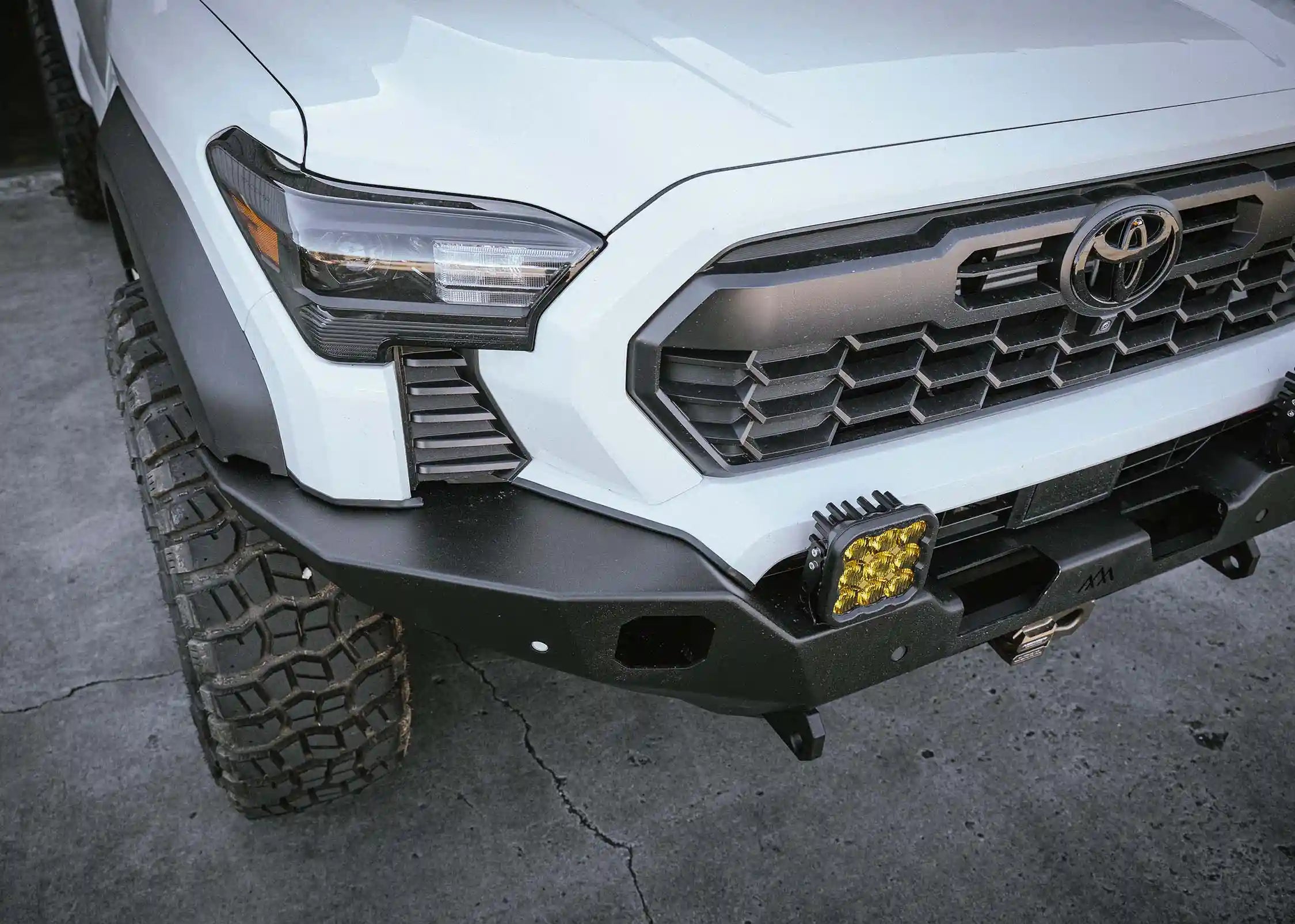 Top view of Backwoods Adventure Mods 2024 Toyota Tacoma 4th Gen Hi-Lite Overland Front Bumper with off road lights installed