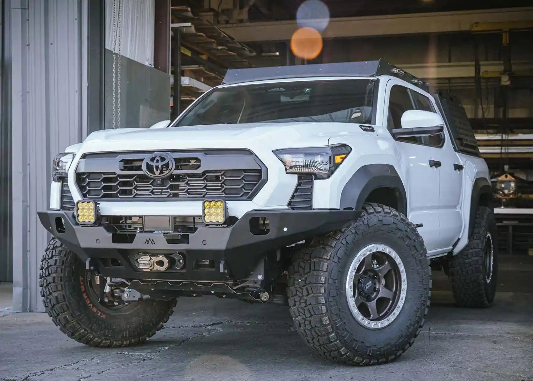 Demonstrating the high clearance of the Backwoods Adventure Mods 2024 Toyota Tacoma 4th Gen Hi-Lite off road Front Bumper