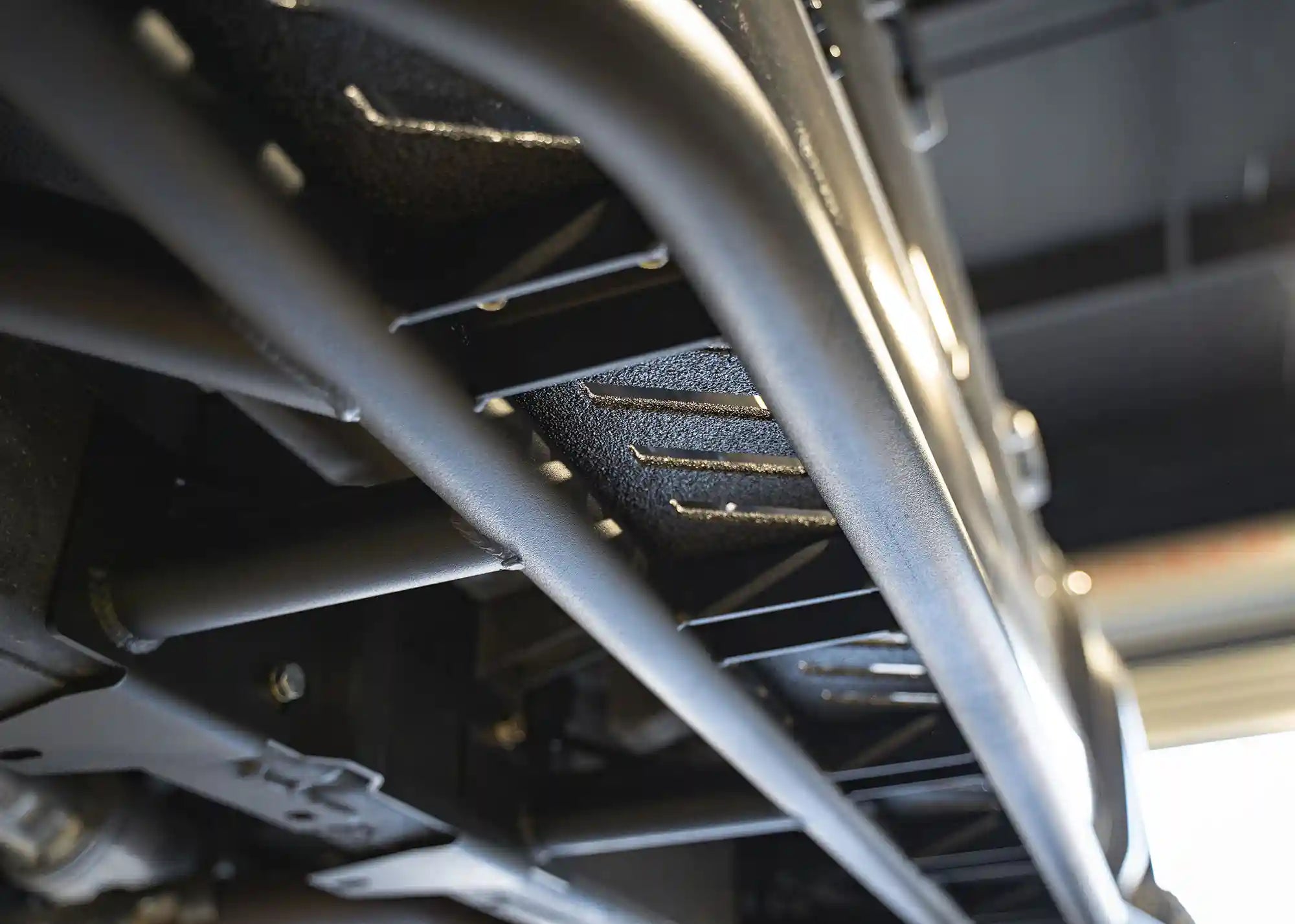 Close up of the underside of the 2024+ Toyota Tacoma Rock Sliders from Backwoods Adventure Mods showing the bolt-on mounting hardware
