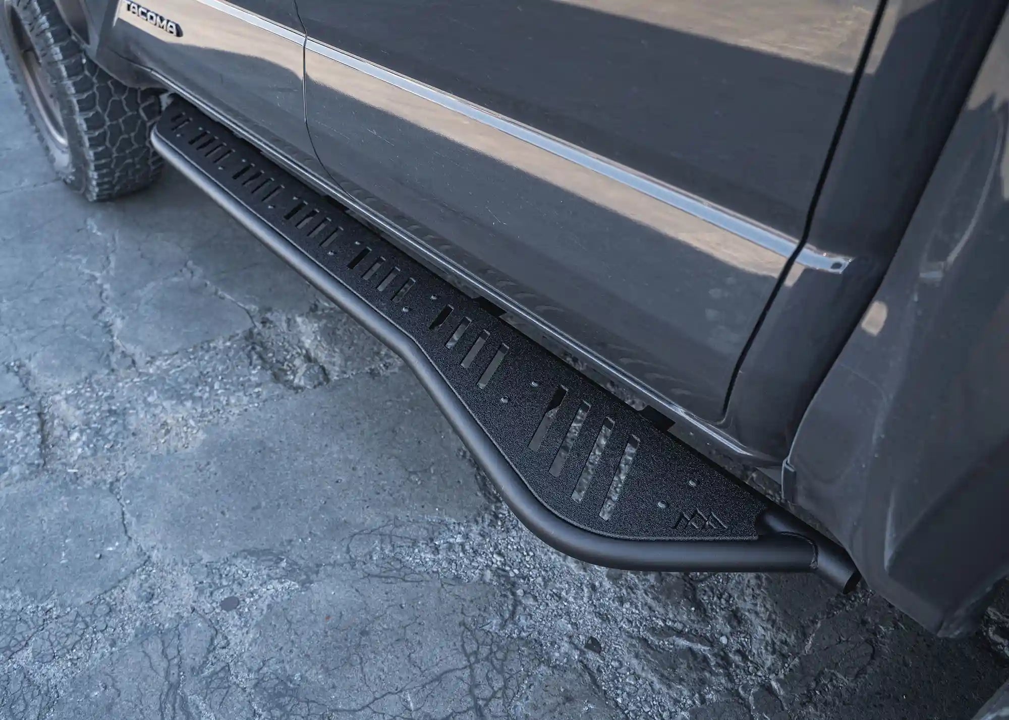 Image showing the textured powder coat finish on the bolt-on 2024-2026 Tacoma Rock Sliders with Side Steps from Backwoods Adventure Mods