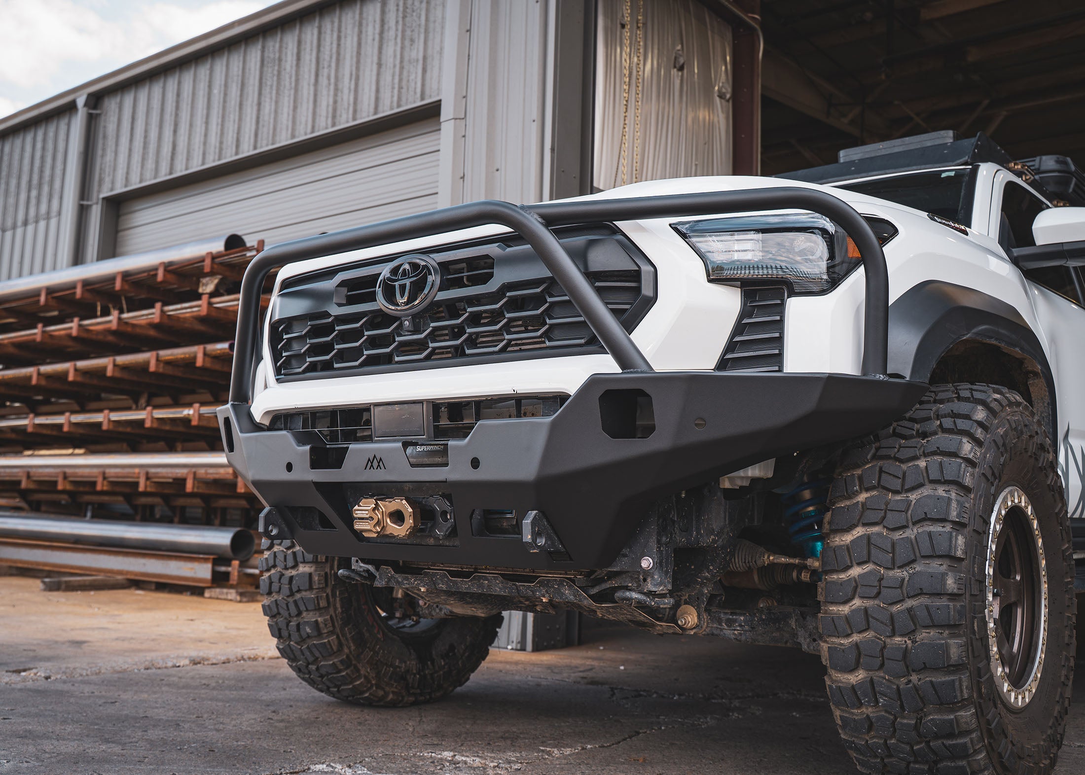 Winch mount and recovery points on the Backwoods Adventure Mods 4th Gen 2024 Toyota Tacoma Hi-Lite Overland Front Bumper with Bull Bar