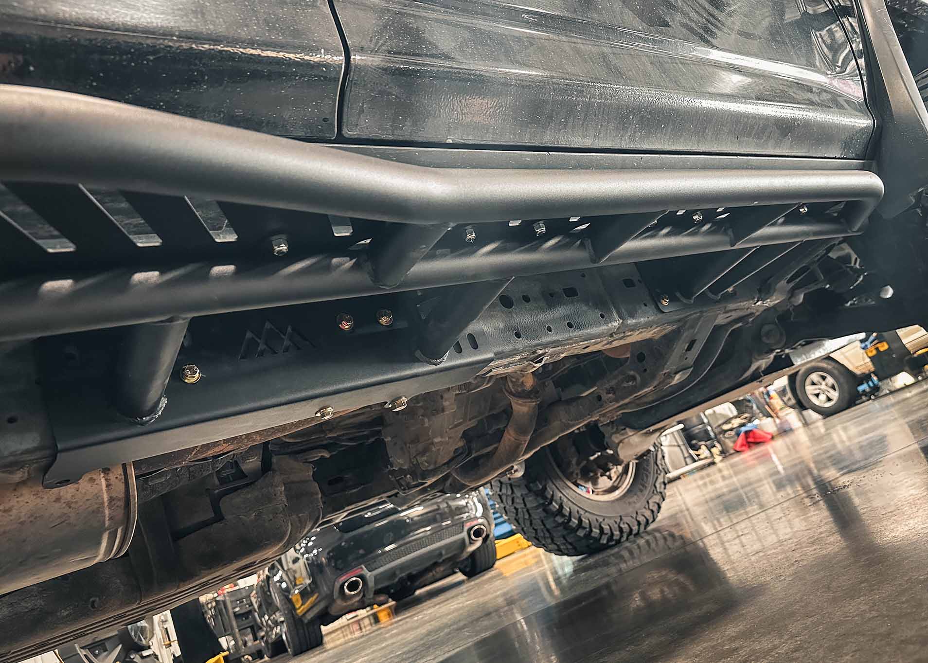 Close up of the bolt-on frame installation of the Backwoods Adventure Mods 2010-2024 5th Gen Toyota 4Runner Rock Sliders