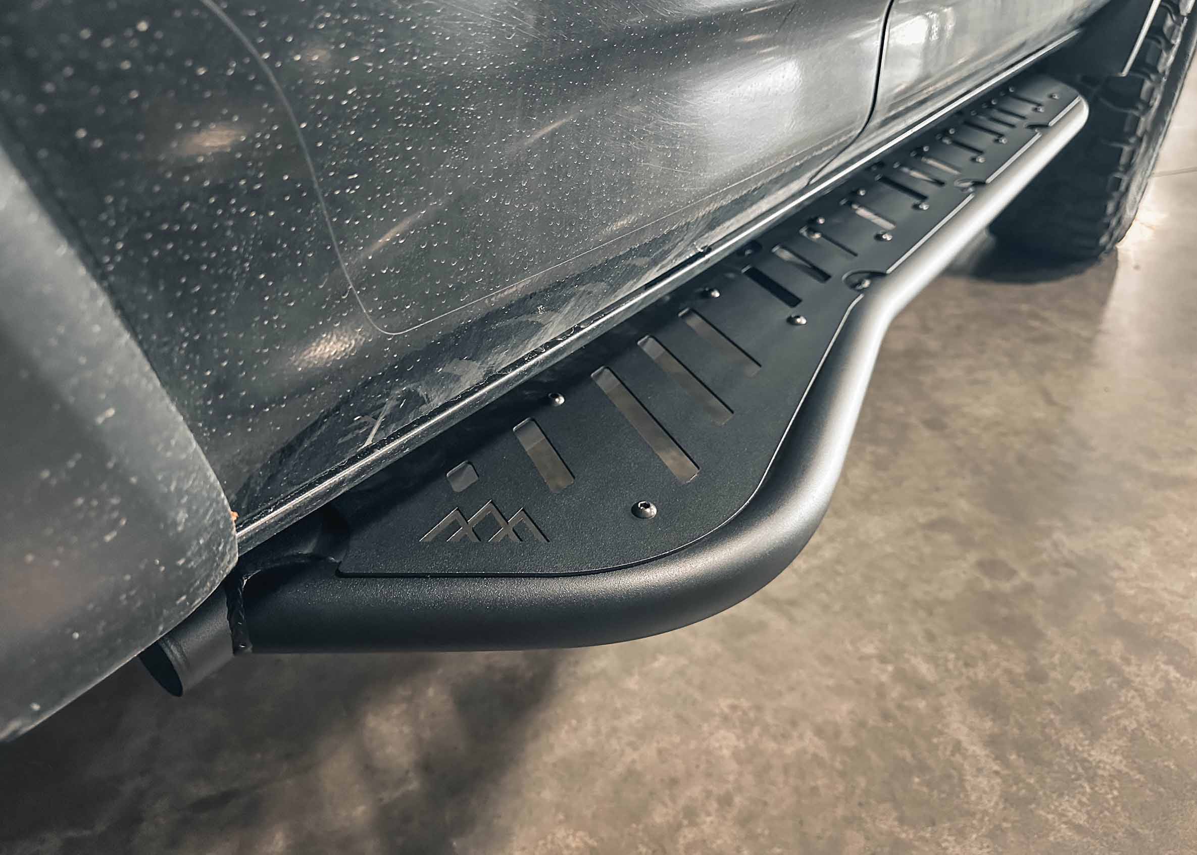 Close up image of the Backwoods Adventure Mods 2010-2024 5th Gen Toyota 4Runner bolt-on Rock Sliders kick-out