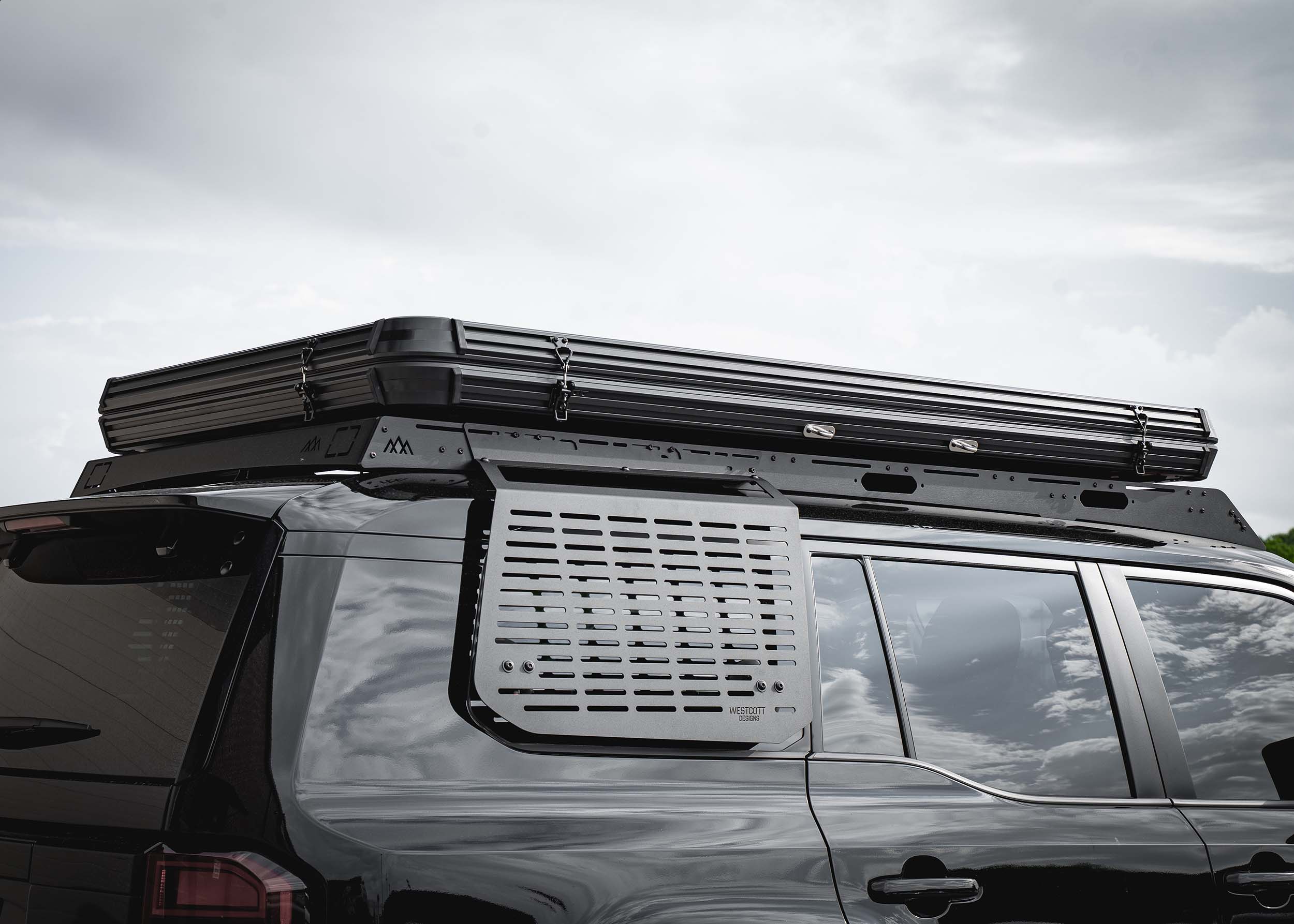 Toyota Land Cruiser 250 series Backwoods Adventure Mods DRIFTR roof rack with a roof top tent mounted on top
