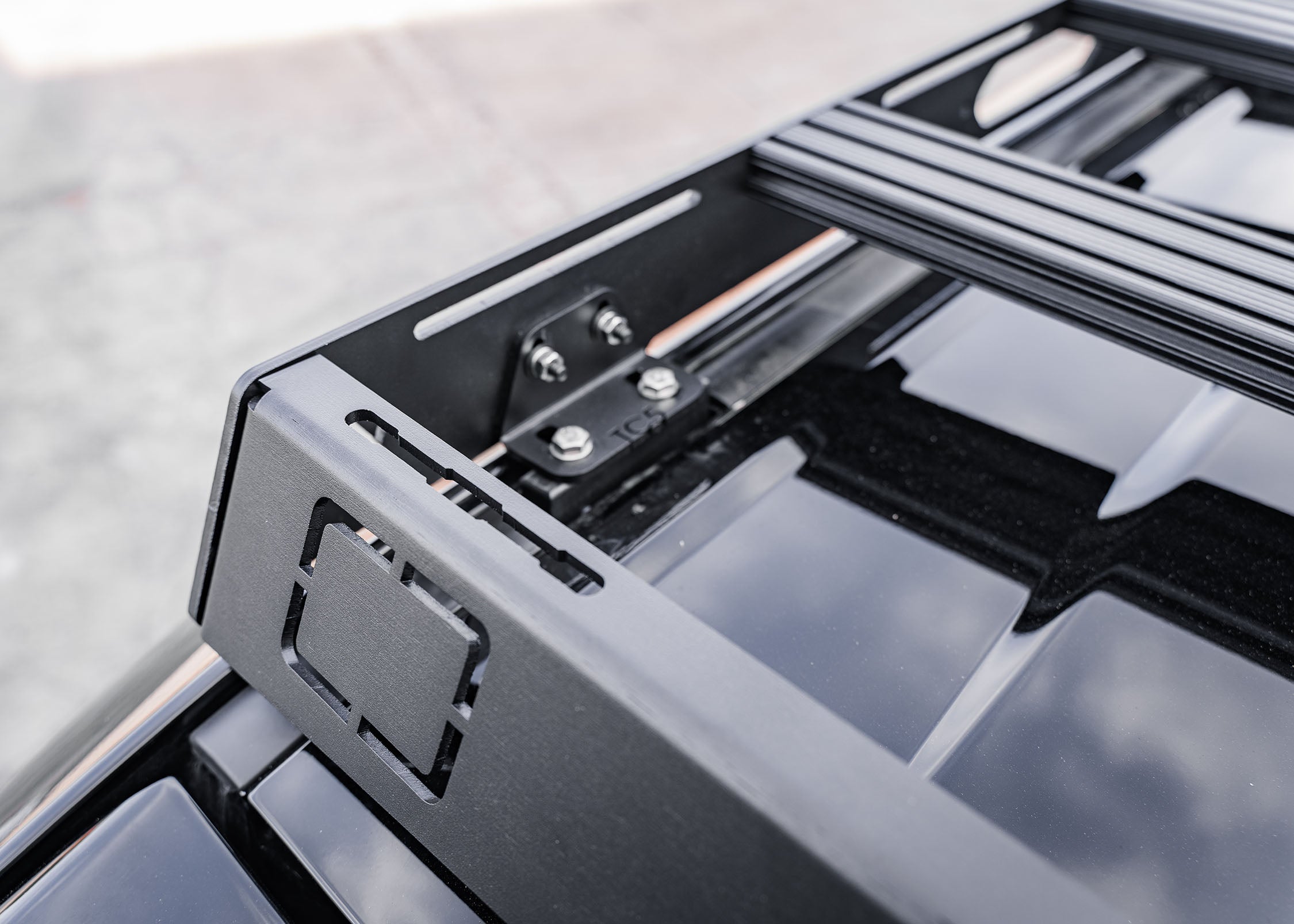 Close up of the mounting bracket and front wind fairing on the Backwoods Adventure Mods DRIFTR roof rack for the Toyota Land Cruiser 250