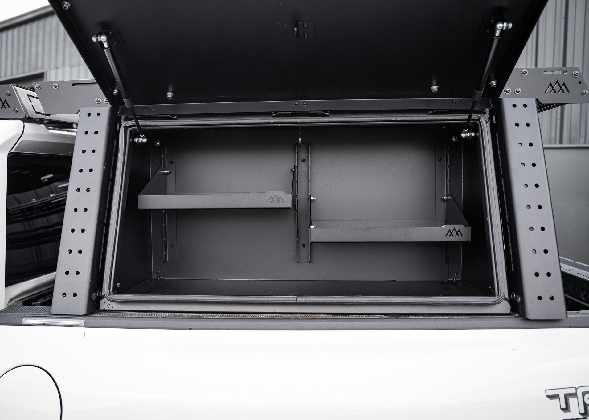 Backwoods Adventure Mods Truck Bed Rack System Overland Enthusiast Bundle installed on a Toyota Tacoma with rack mounted cargo box open