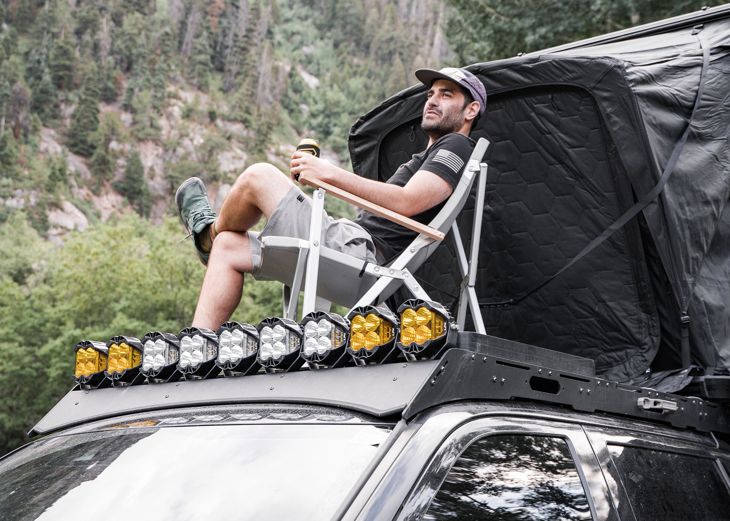 Man usind a Backwoods Adventure Mods DRIFTR roof rack to camp on his 3rd gen Toyota Tundra overland truck build