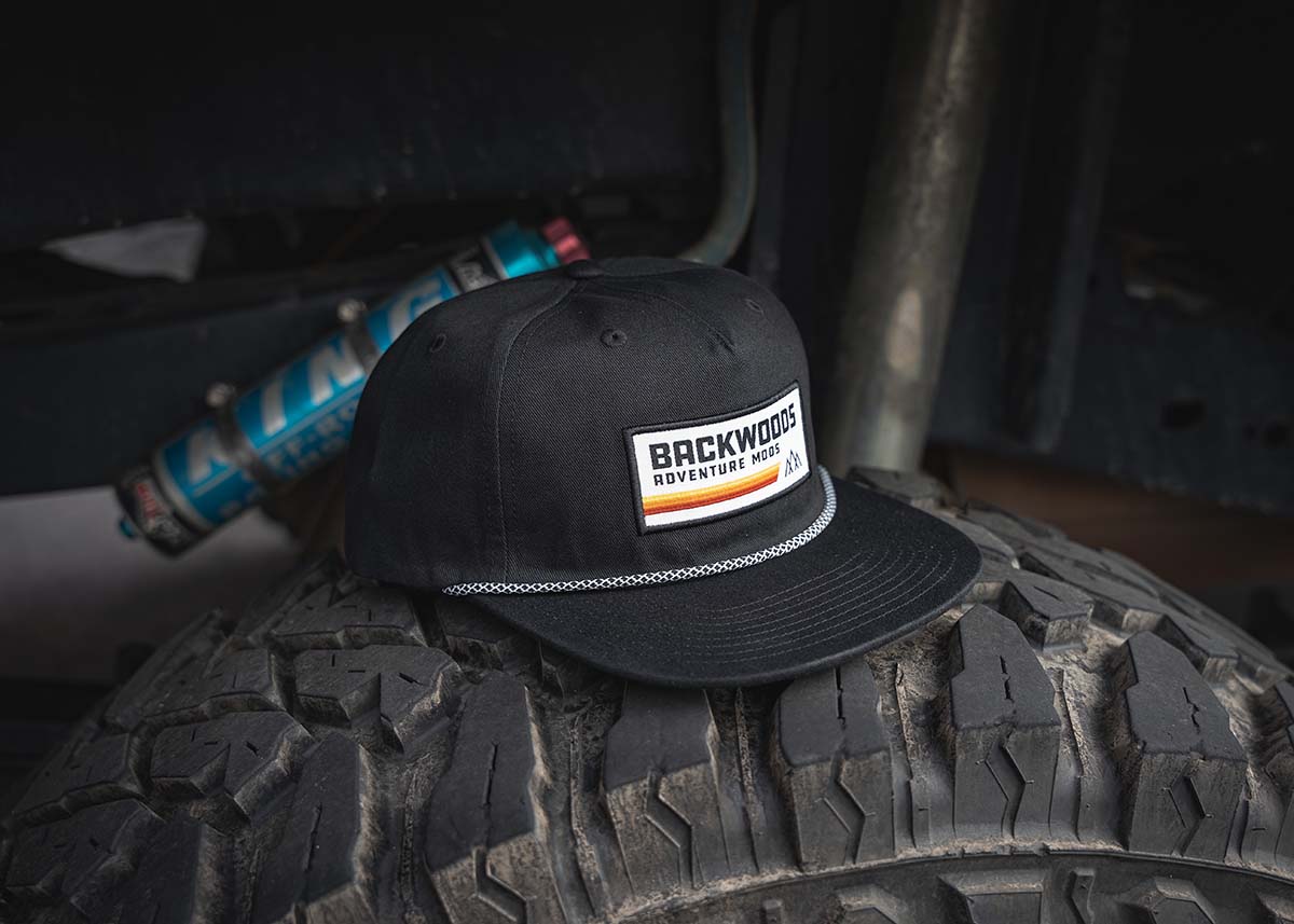 Backwoods Adventure Mods Heritage Rope hat sitting on top of an off road tire