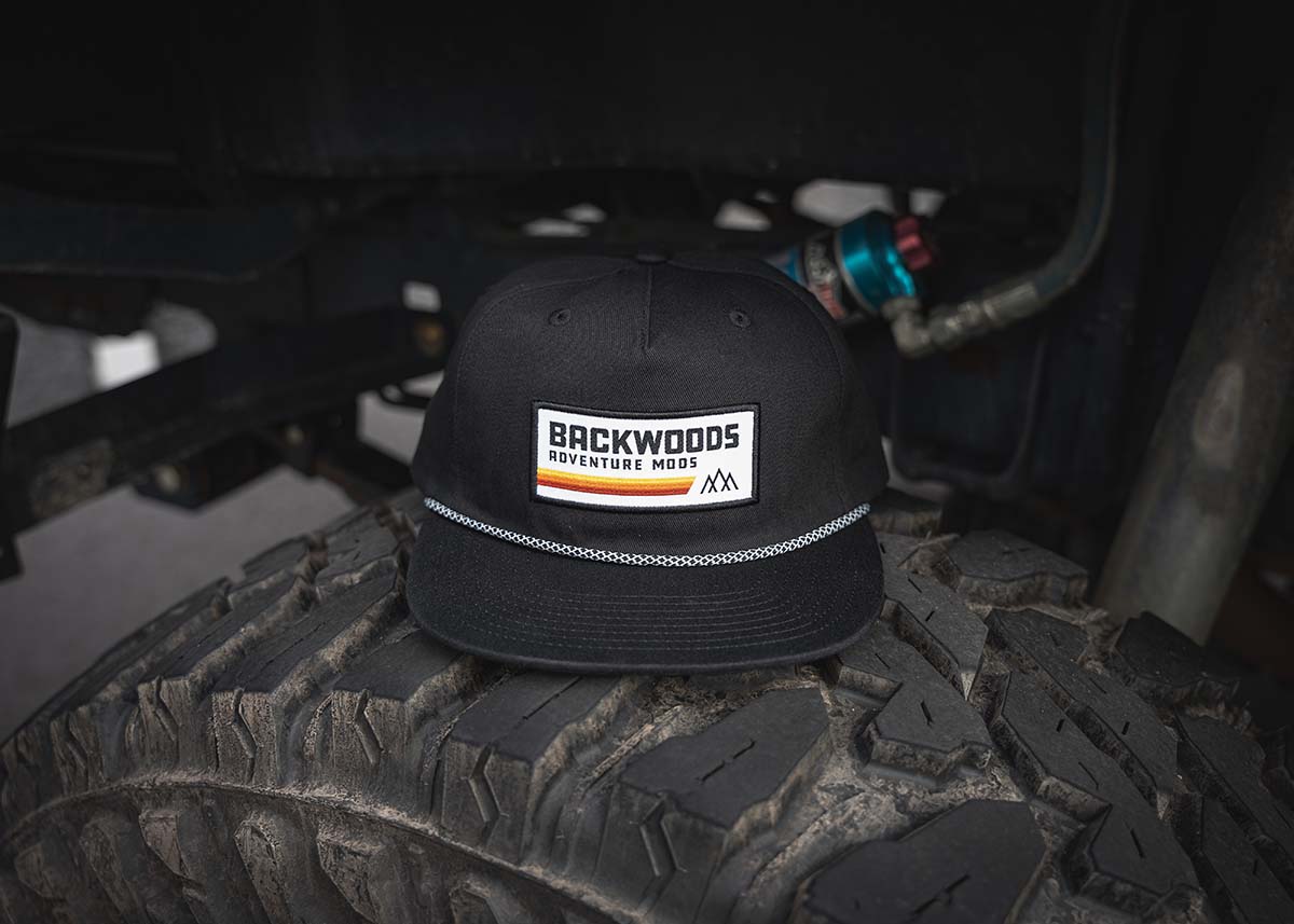 Backwoods Adventure Mods Heritage Rope hat sitting on top of an off road vehicle tire