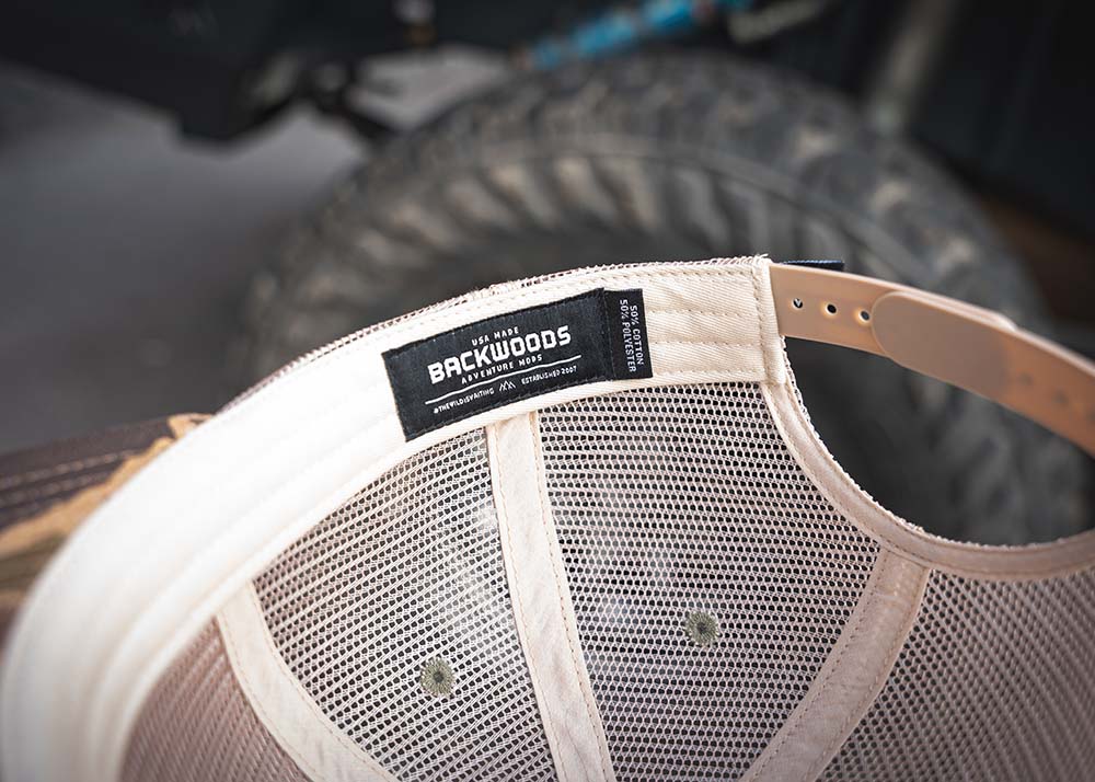 Image showing the interior label of the Backwoods Adventure Mods Camo Trucker hat baseball cap
