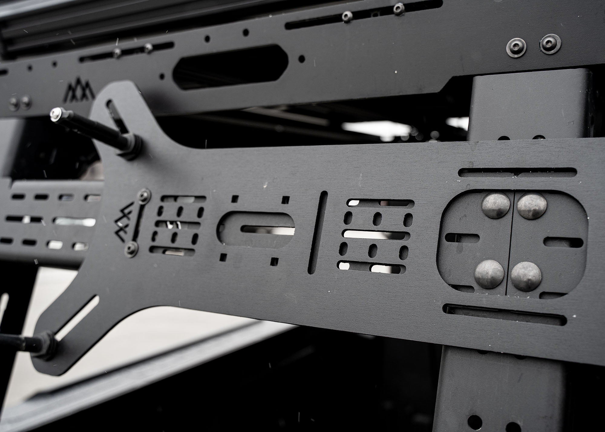 Close up of the Backwoods Adventure Mods Dogbone Universal Traction Board Mount for off road recovery board storage