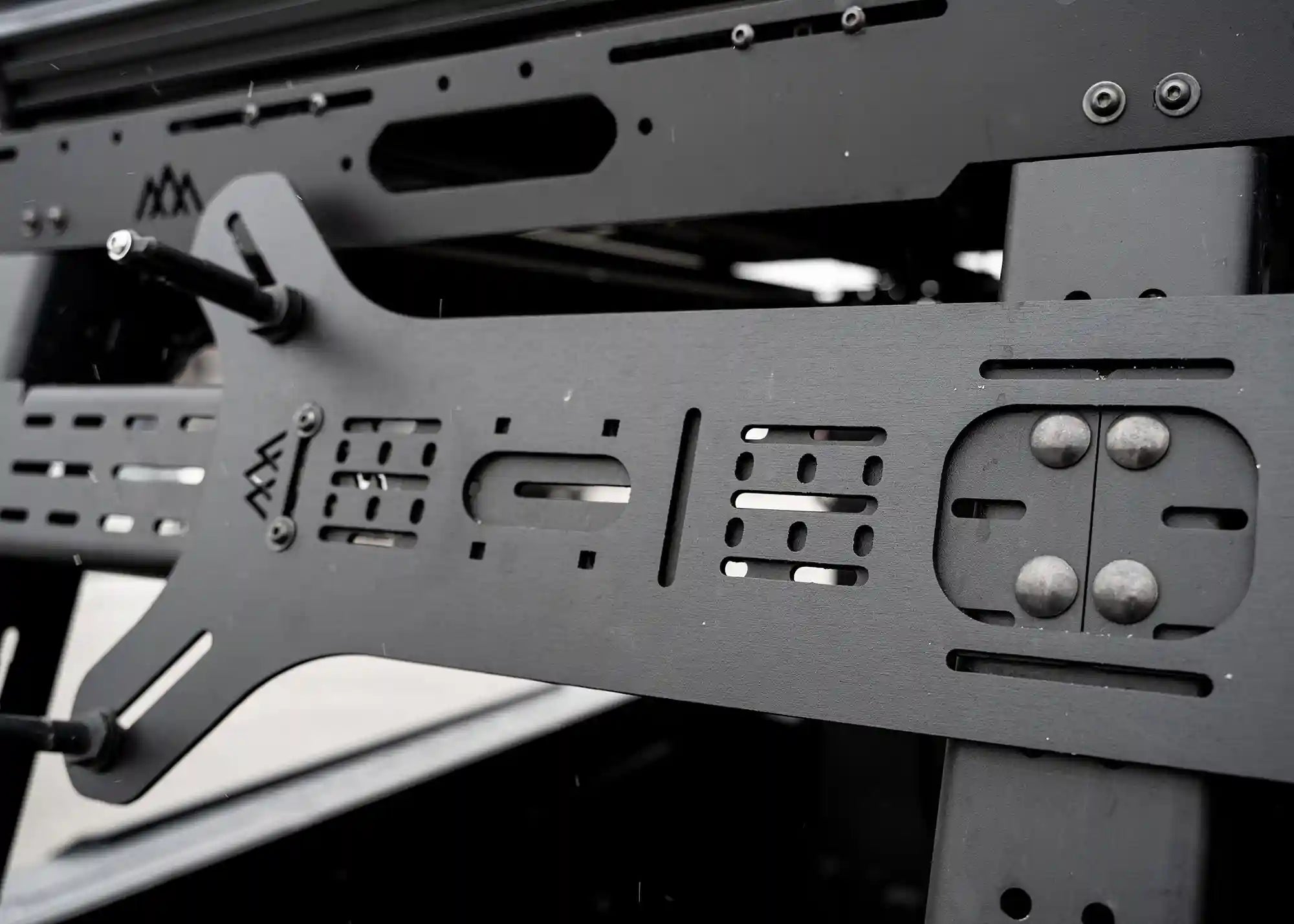 Close up of the Backwoods Adventure Mods Dogbone Universal Traction Board Mount for off road recovery board storage