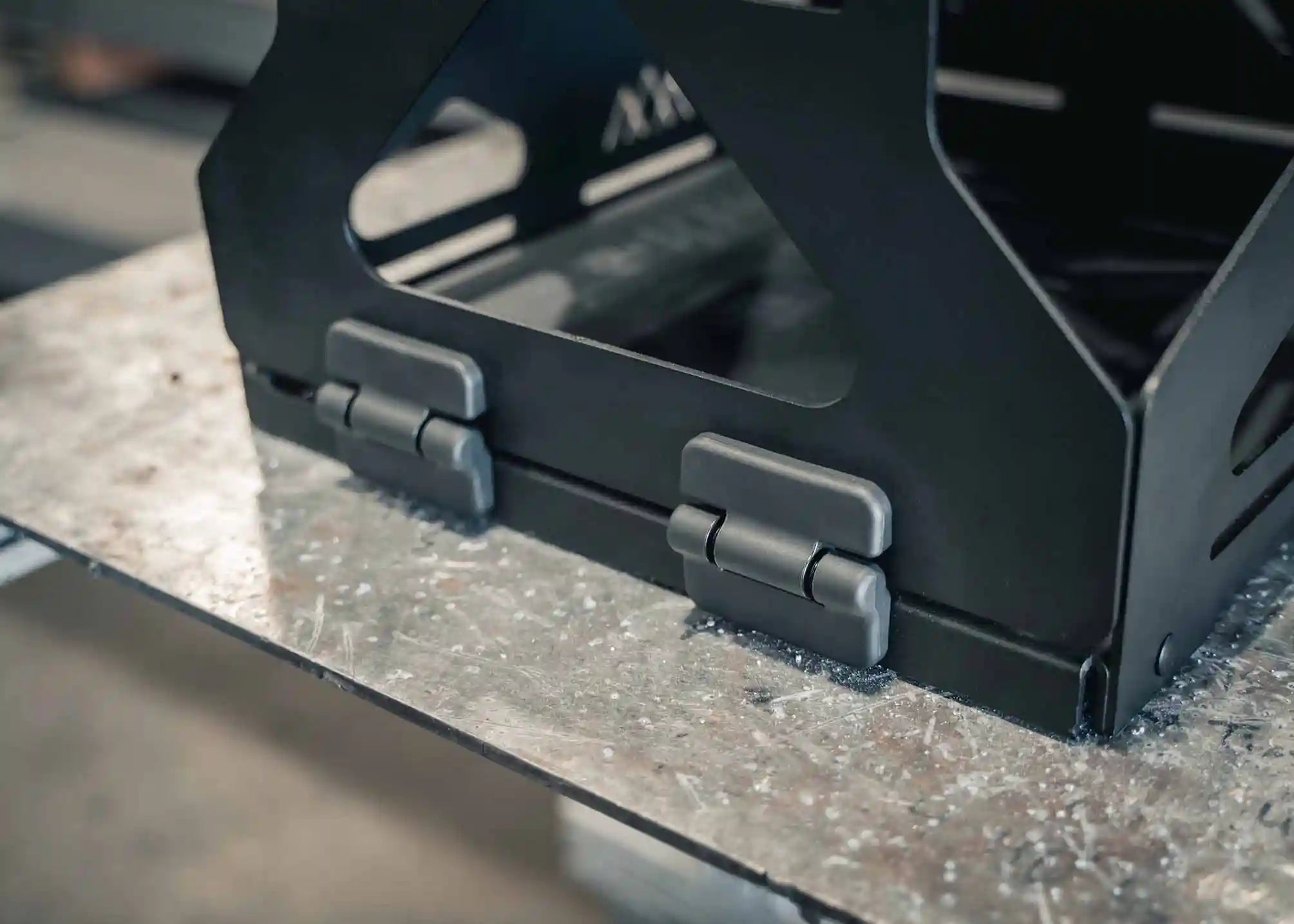 Close up image of the heavy-duty hinges on the Jerry's Can Holder - Dual Universal Jerry Can Mount from Backwoods Adventure Mods