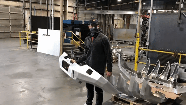 Man lifting the 5th Gen Toyota 4Runner Front Bumper with one hand demonstrating it's light weight and ease of install
