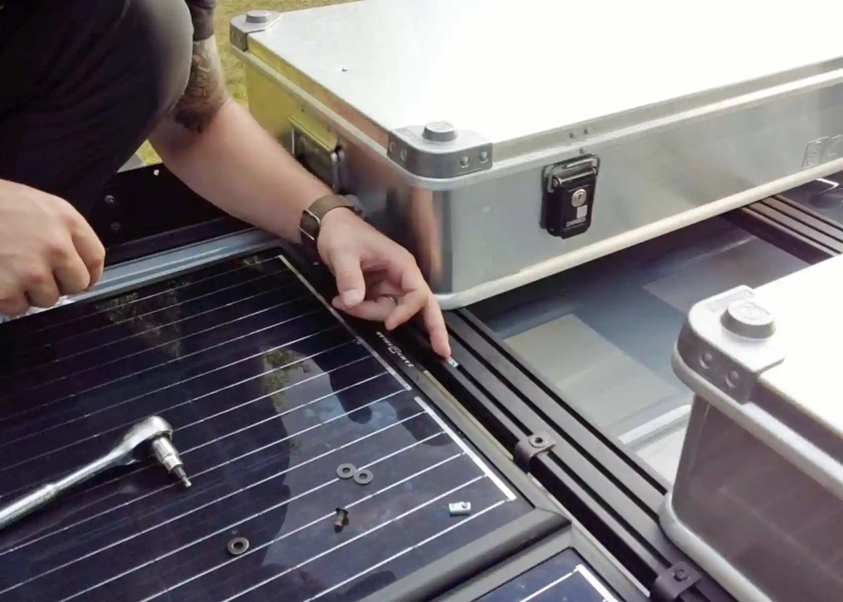 Image of person securing accessories to thier Backwoods Adventure Mods DRIFTR Roof Rack using the Sliding T-NUT Hardware kit