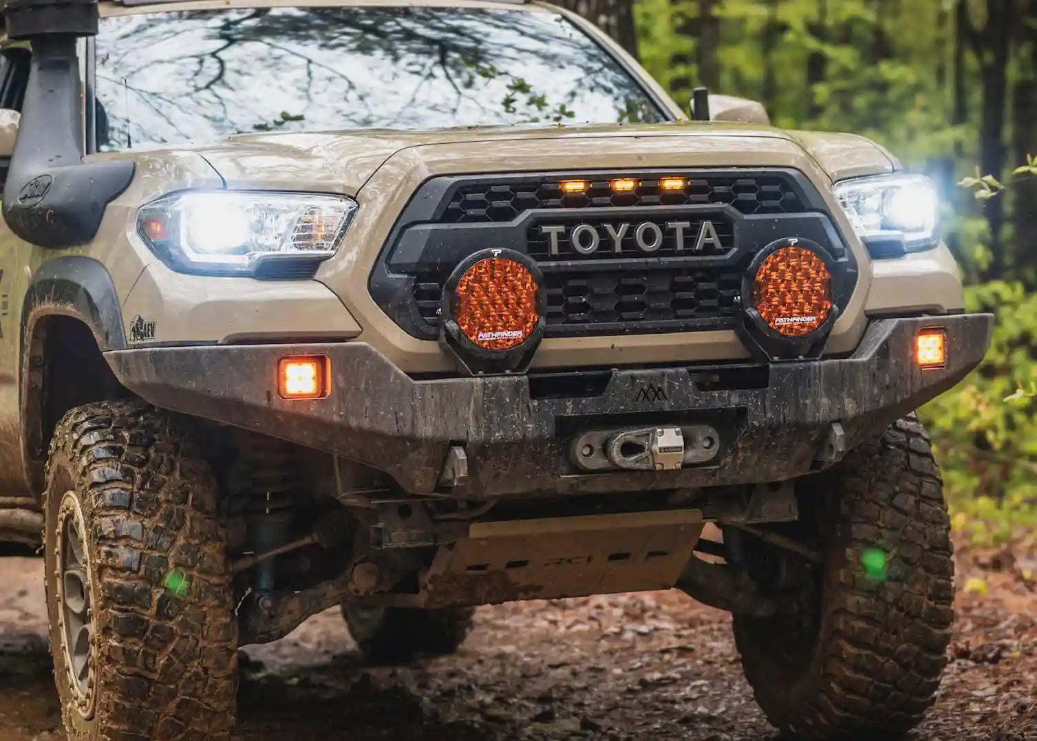 Pair of Pathfinder PROWLR 9 inch Amber LED Off Road Driving Lights installed on a Backwoods Adventure Mods Hi-Lite series Toyota Tacoma hybrid high clearance bumper