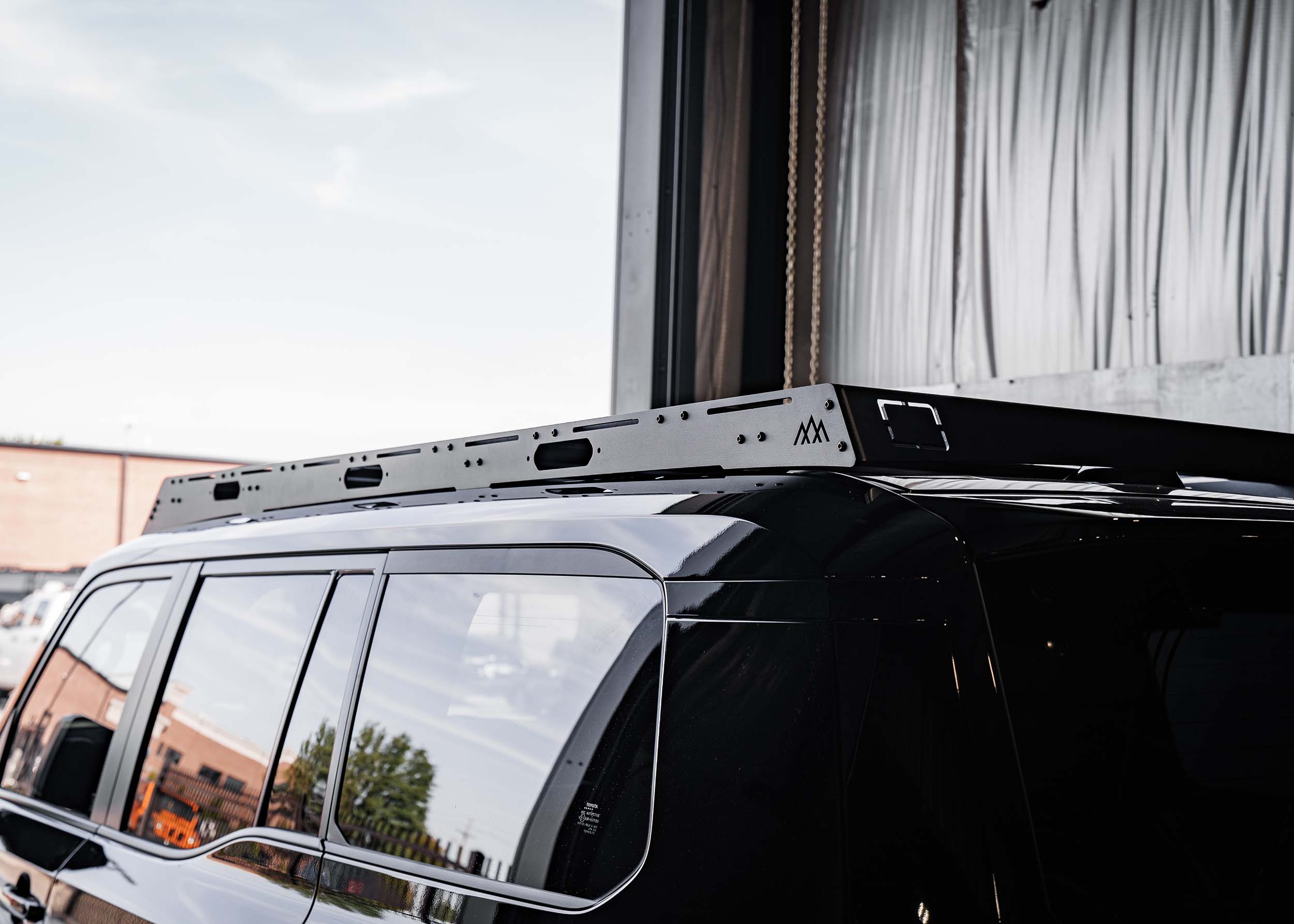 Black Toyota Landcruiser 250 with low-profile Backwoods Adventure Mods DRIFTR roof rack installed