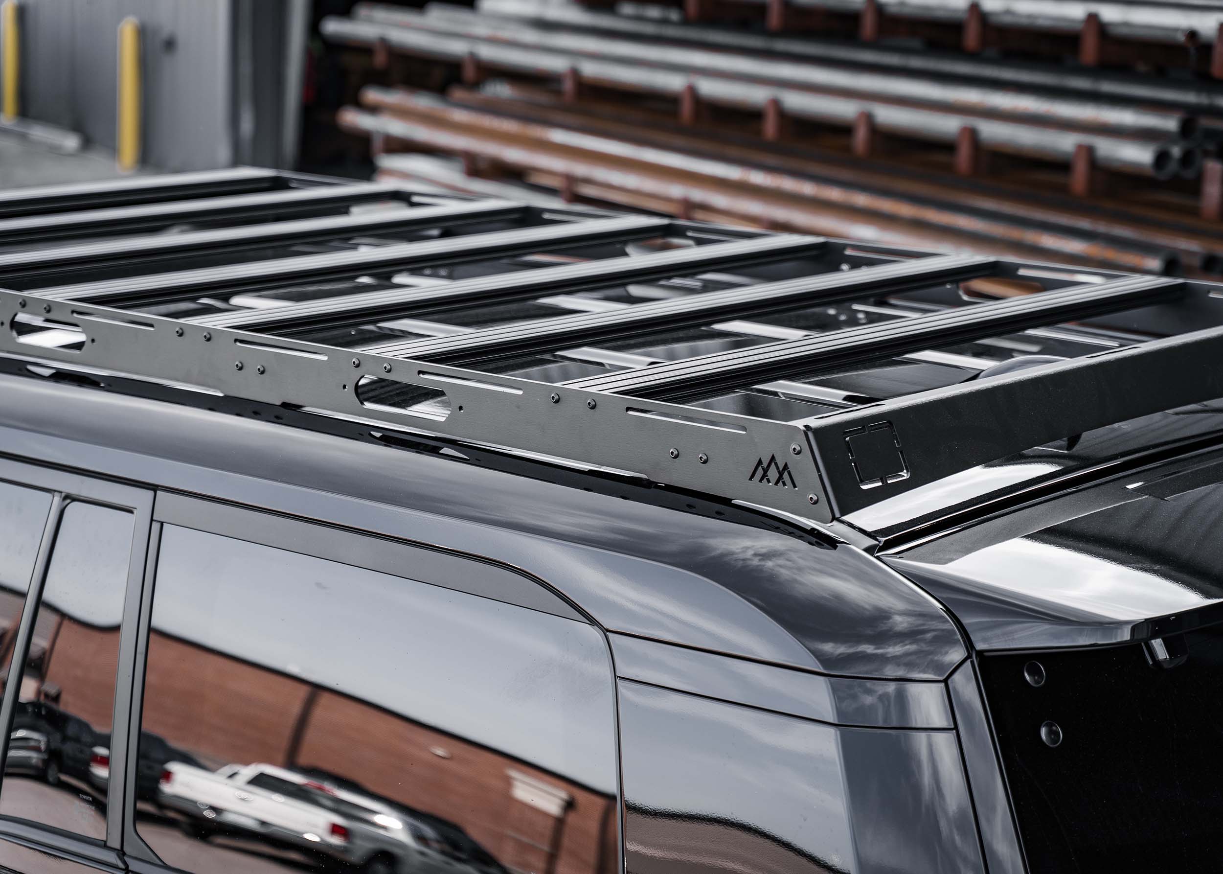 T-track accessory load bars included with the Backwoods Adventure Mods DRIFTR roof rack for Toyota Land Cruiser 250