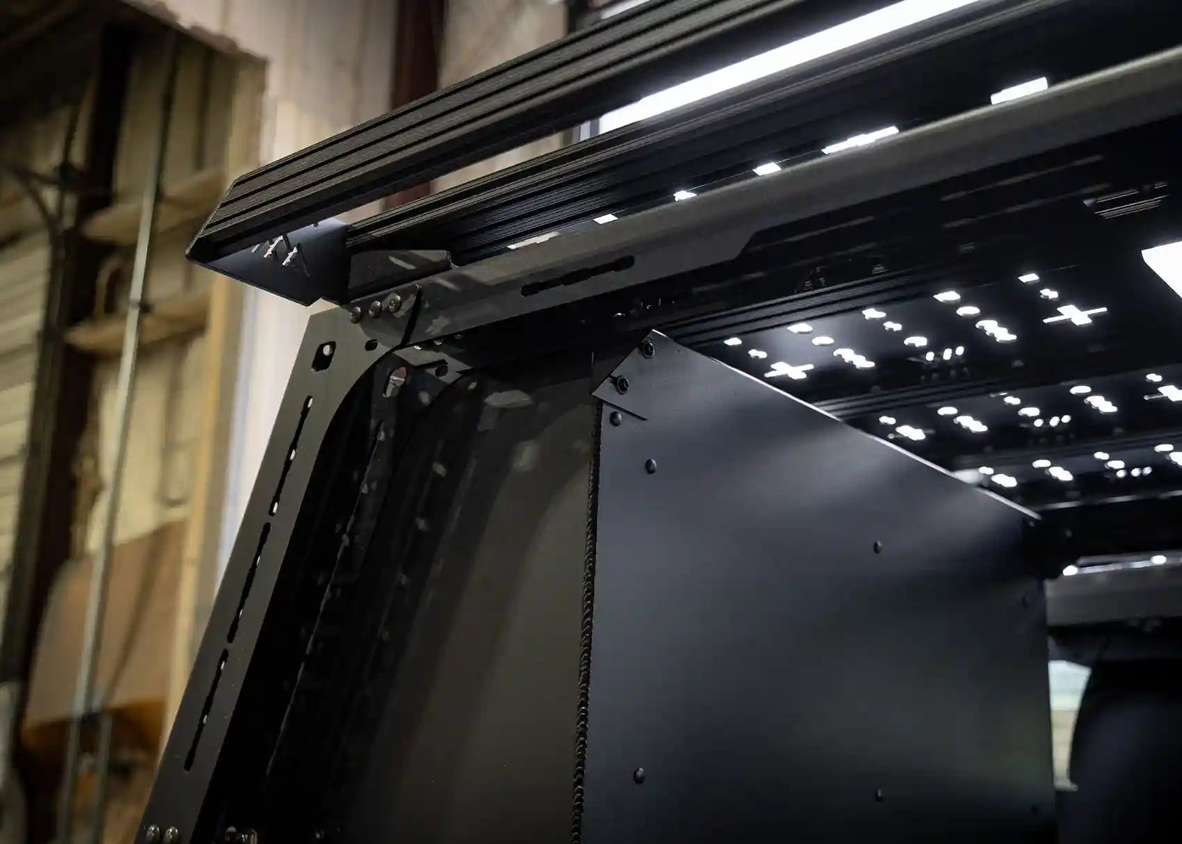 Image of the back side of the Backwoods Adventure Mods Toyota Tacoma bed rack storage box taken from inside the truck bed