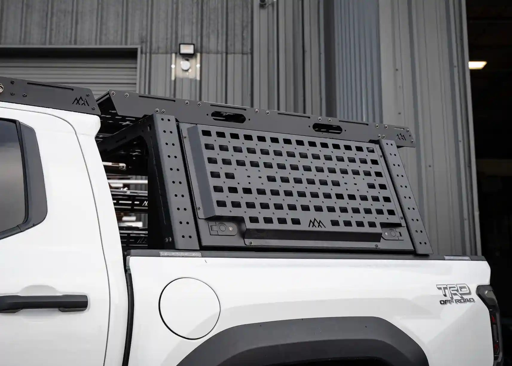 Exterior molle panels for gear organization on the Backwoods Adventure Mods Toyota Tacoma bed rack storage box