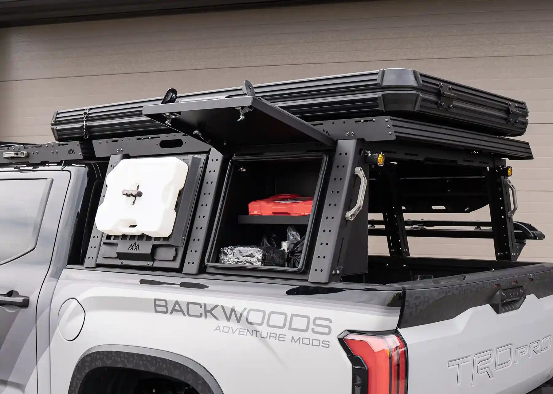 Front of the Backwoods Adventure Mods Toyota Tundra Aluminum Bed Rack Storage Box with lid open