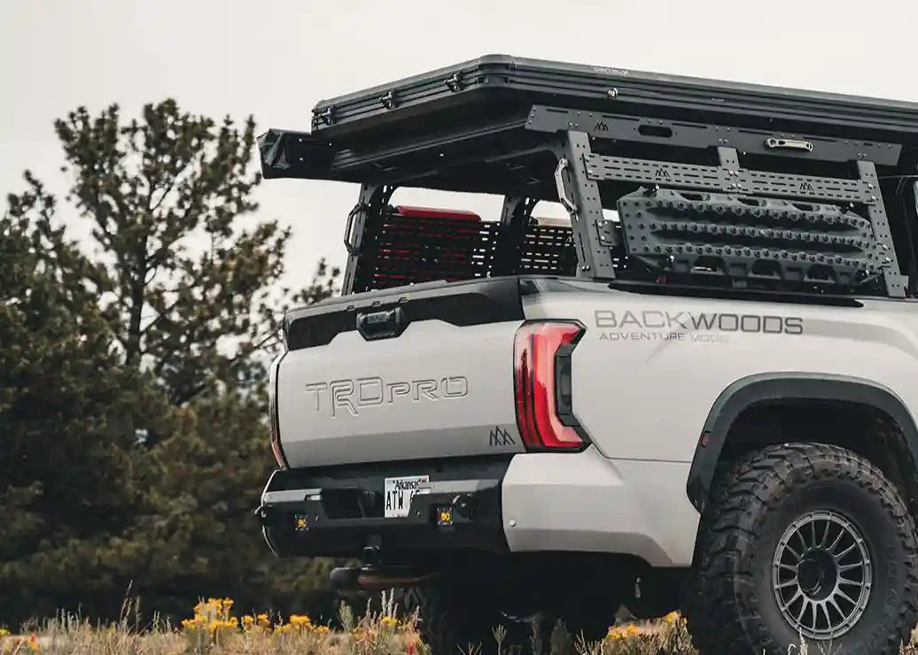 Rear view of a Toyota Tundra overland build with a Backwoods Adventure Mods Truck Bed Rack System Starter Bundle installed for organizing cargo and off road gear