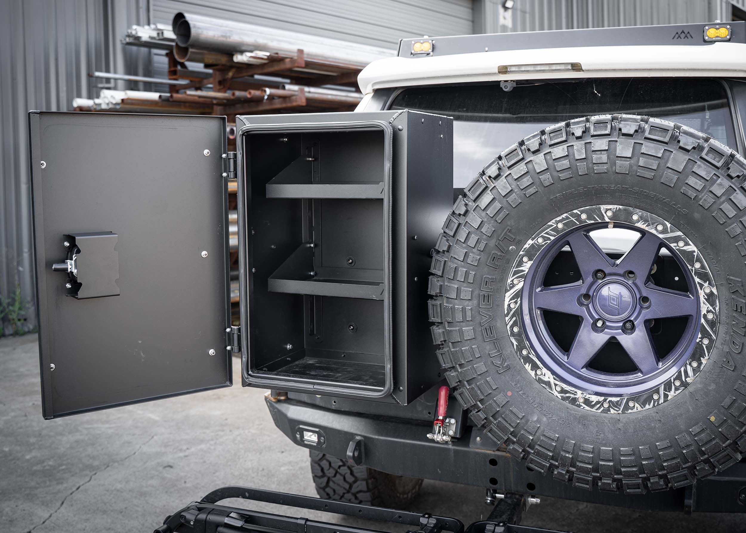 Interior of the Backwoods Adventure Mods Universal off-road vehicle overland gear storage cargo box installed on a white Toyota 4Runner