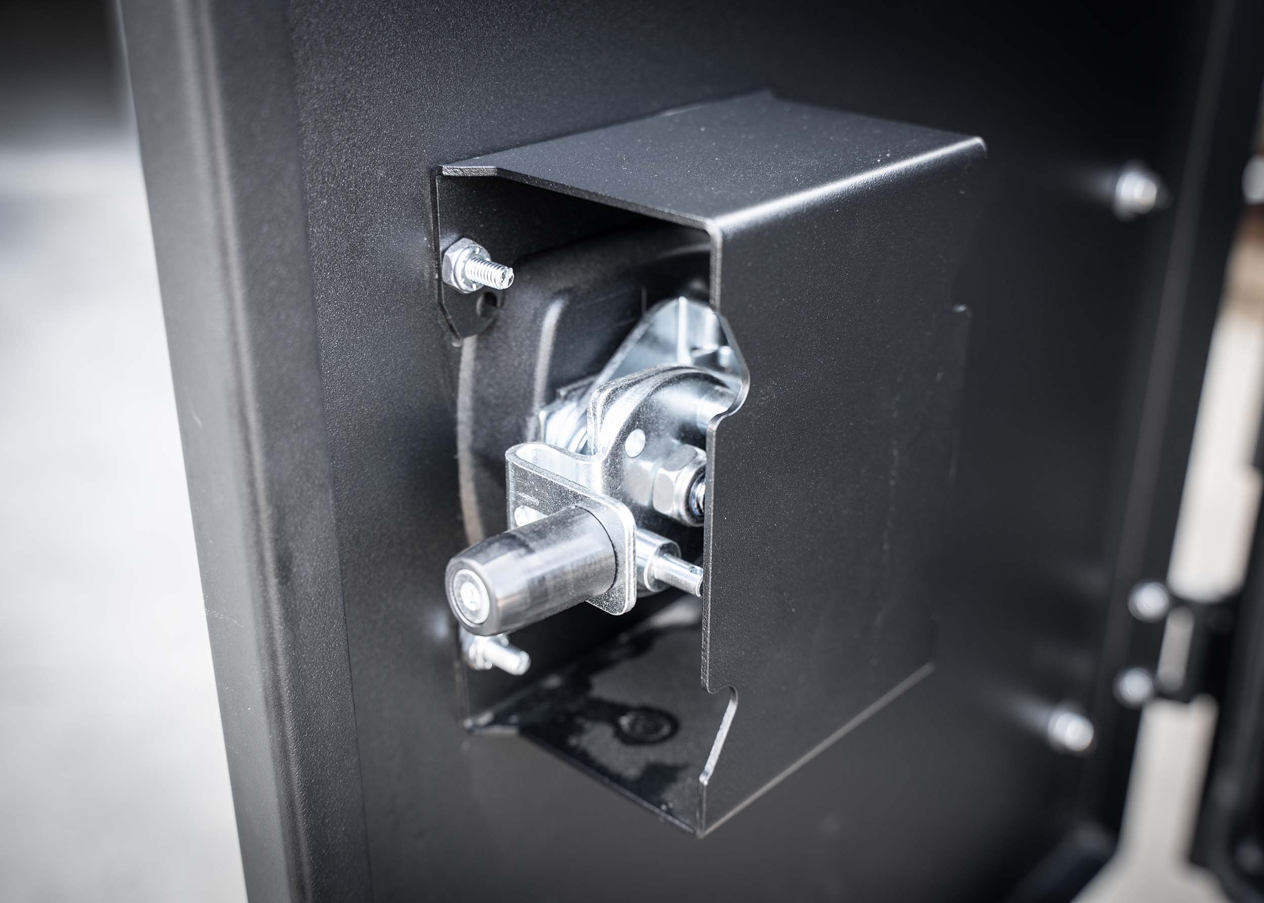 Heavy-duty lock mechanism on the Backwoods Adventure Mods Universal off-road vehicle overland gear storage cargo box attached to a white truck