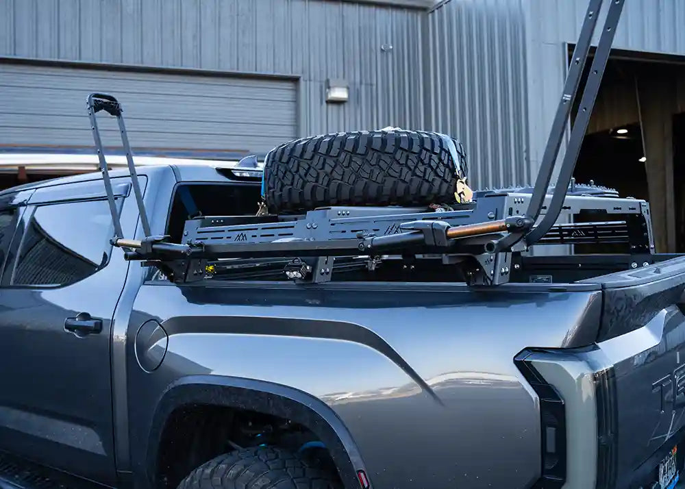 Backwoods Adventure Mods Universal Truck Bed Rack Bike Tray Mounting Brackets installed with a Kuat bike tray mounted to a Toyota Tundra Bed Rack