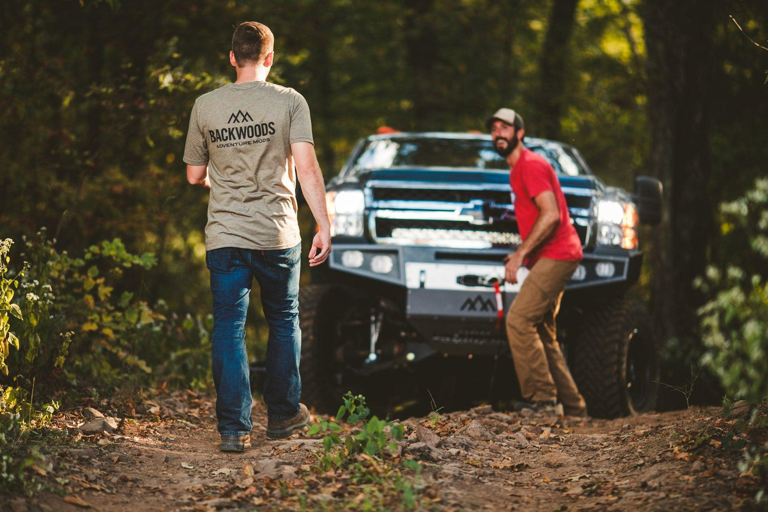 two guys off roading performing an off road winch recovery with a backwoods winch bumper