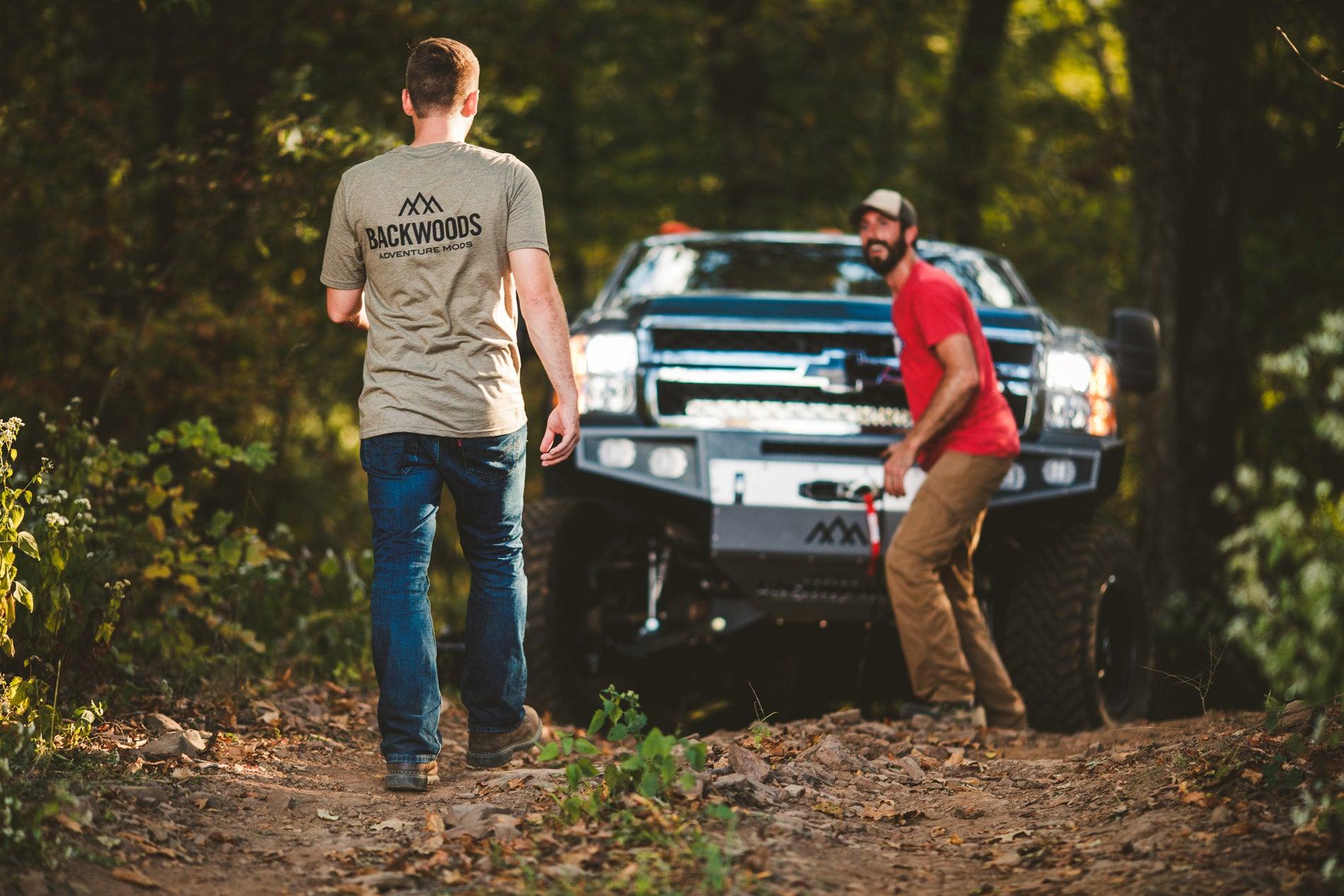 two guys off roading performing an off road winch recovery with a backwoods winch bumper
