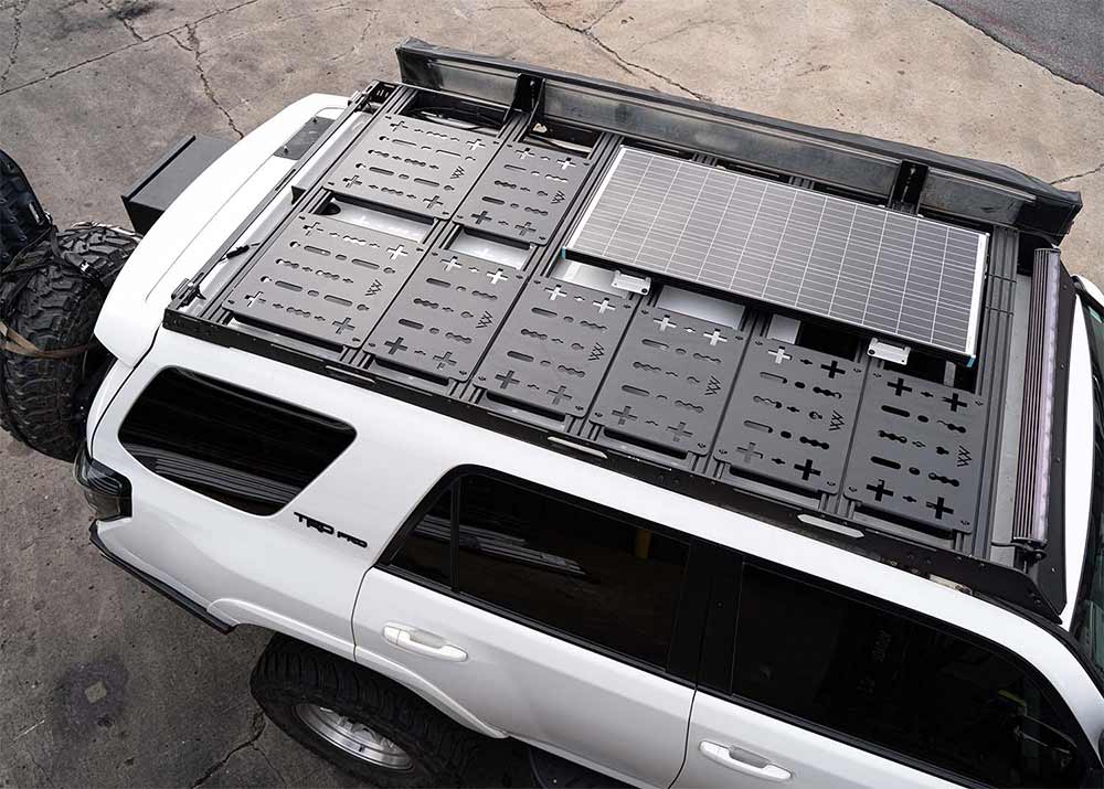 A man loading boxes into the bed of a pickup truck.