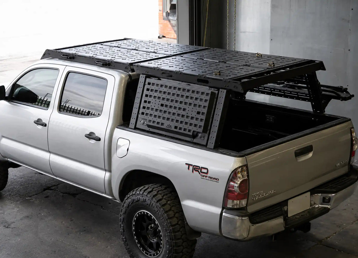 2nd Gen Tacoma mods from Backwoods Adventure Mods - including overland bed rack, roof rack, storage boxes, skid plates, and rack accessories - installed on a 2nd Gen Toyota Tacoma
