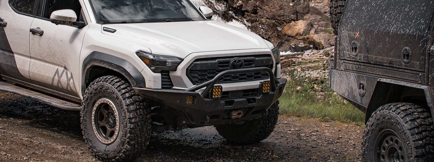 A 2024 toyota tacoma with a backwoods adventure mods front bumper for offroading and overlanding.