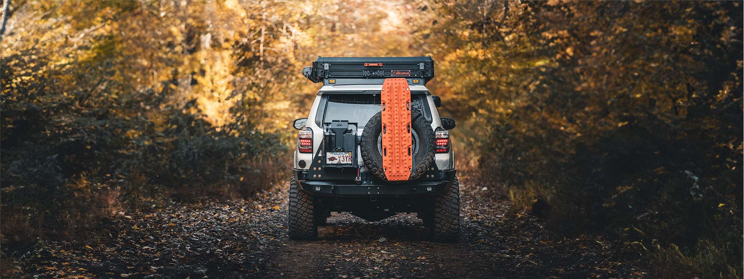 An overland style 5th gen toyota 4Runner in the forest 