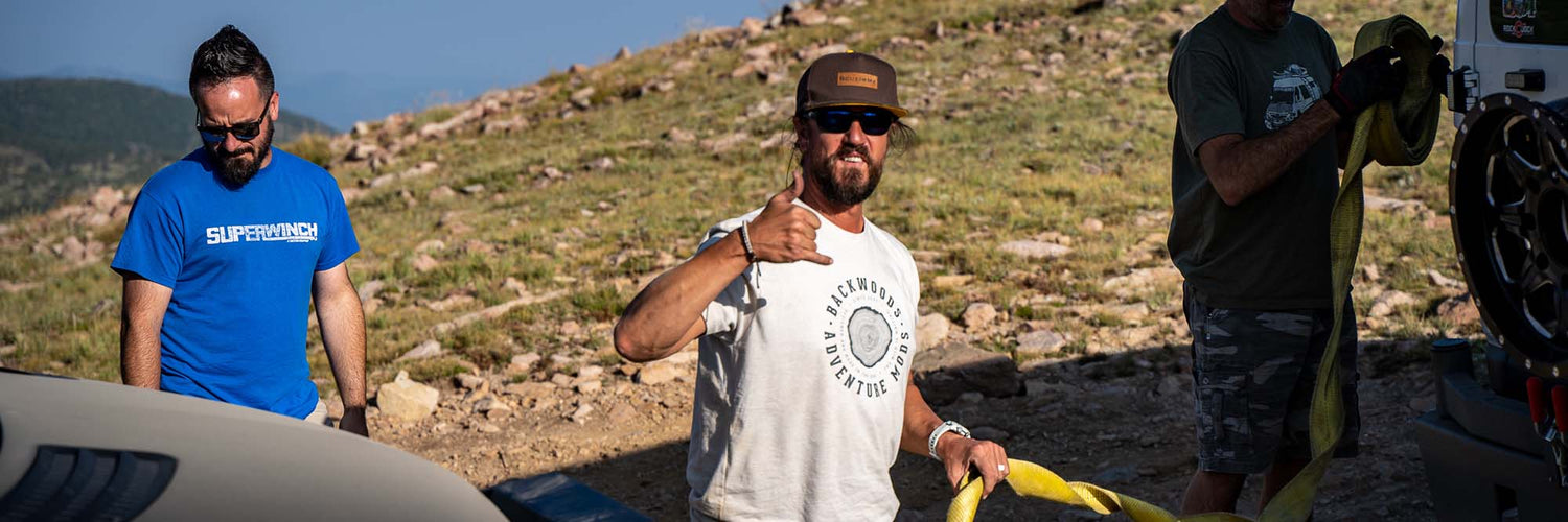 Man driving off road wearing branded clothing and apparel from Backwoods Adventure Mods