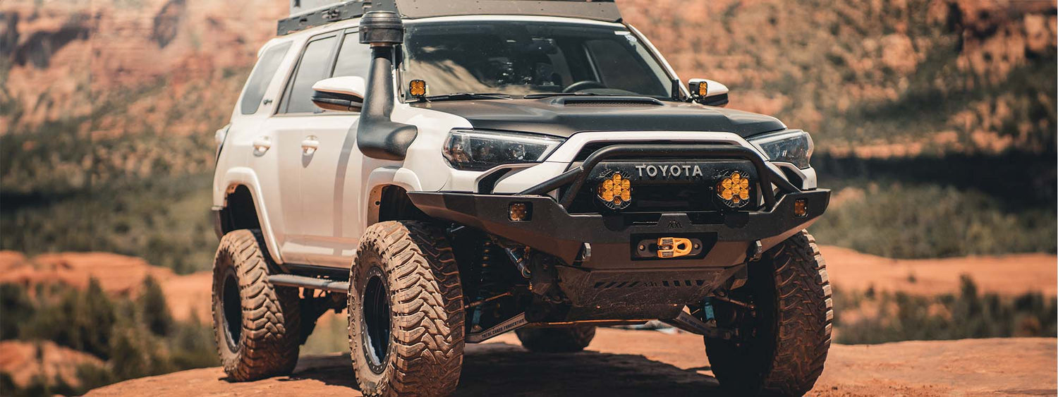 A 5th gen toyota 4runner with a hi-lite series overland backwoods adventure mods front bumper
