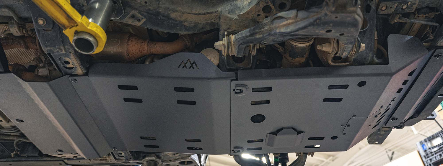 Black powder coated skid plates on the bottom of a 2018 Toyota Tacoma.